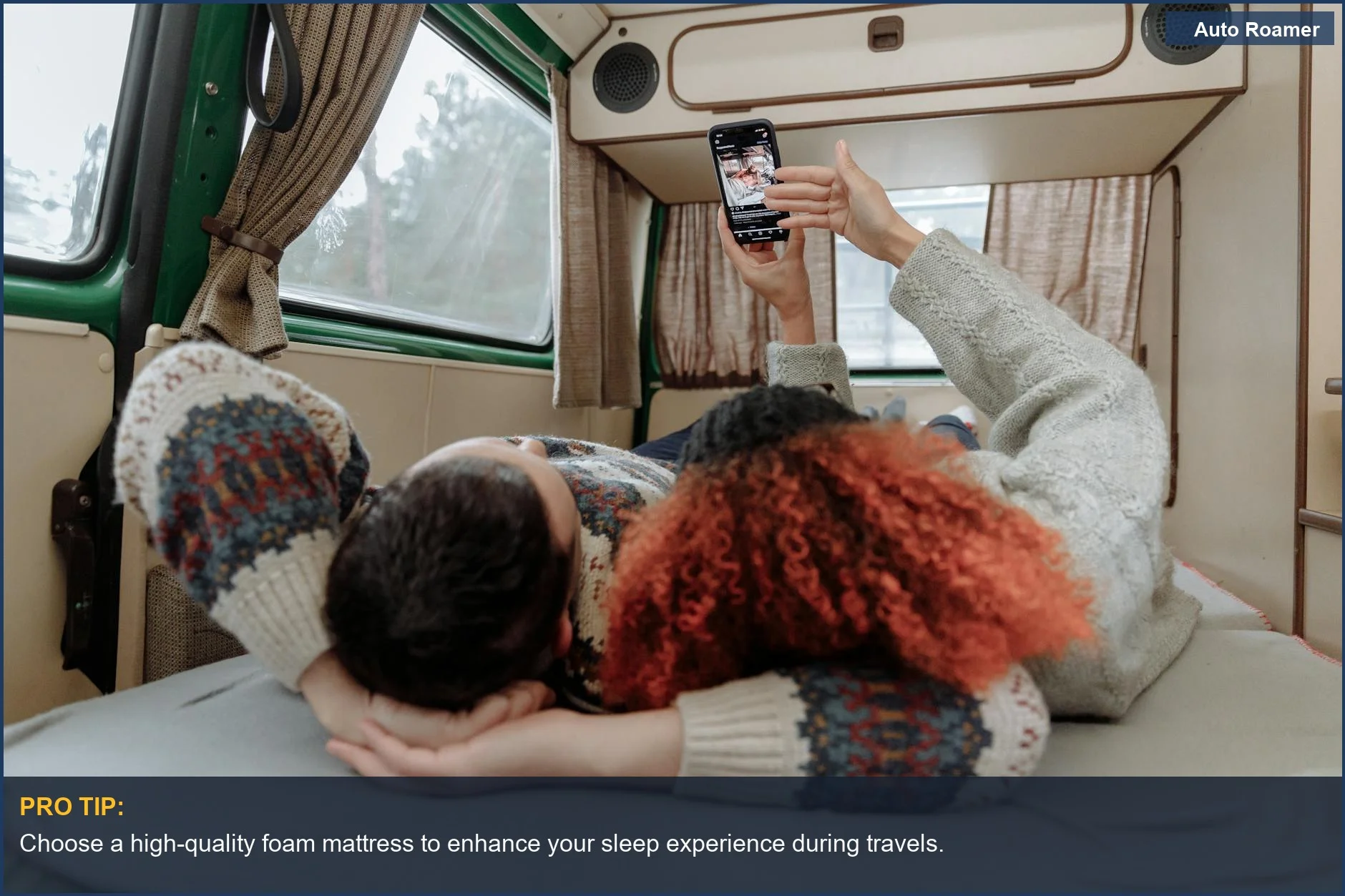 Couple relaxing in a cozy Volkswagen California camper van, streaming videos on a smartphone.