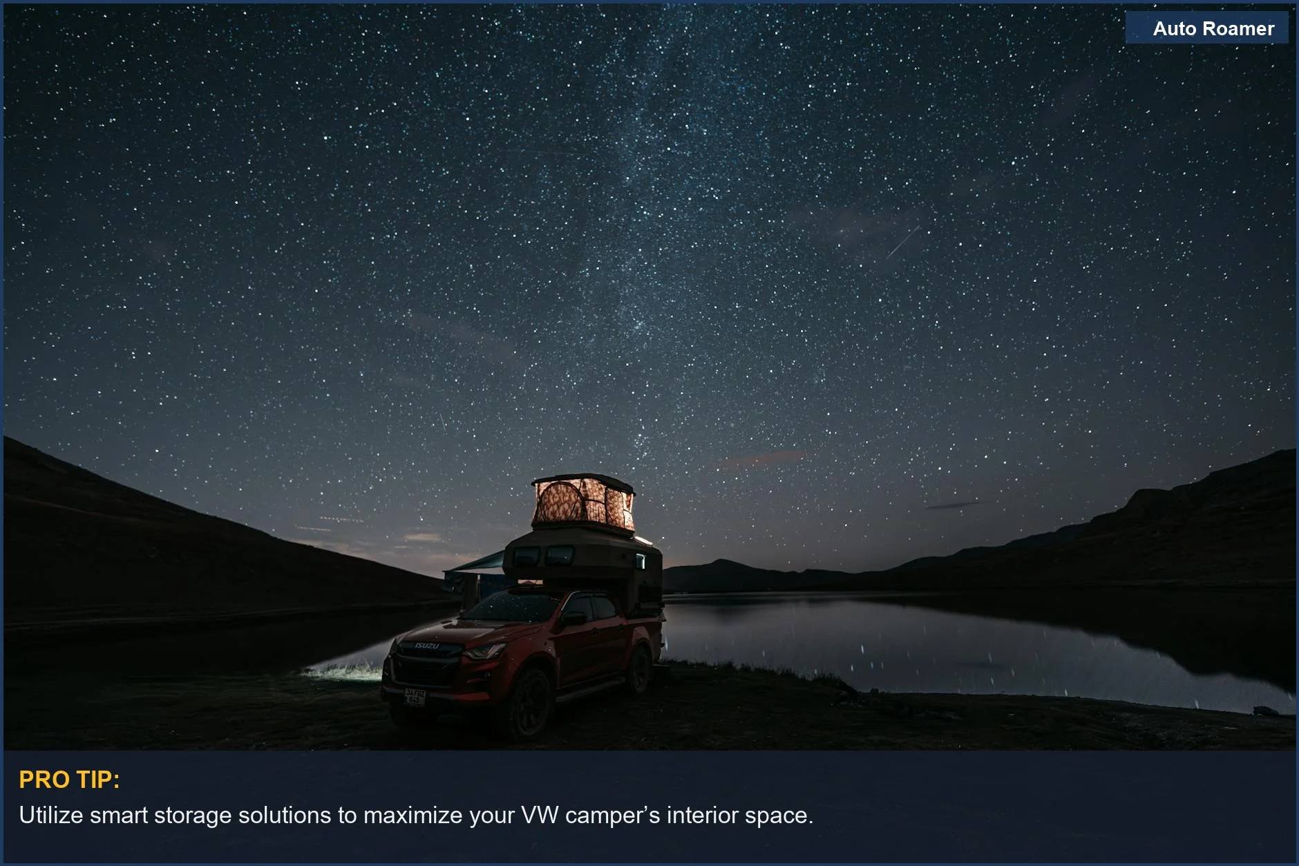 Lakeside camping scene featuring a pick-up truck under a starry sky.
