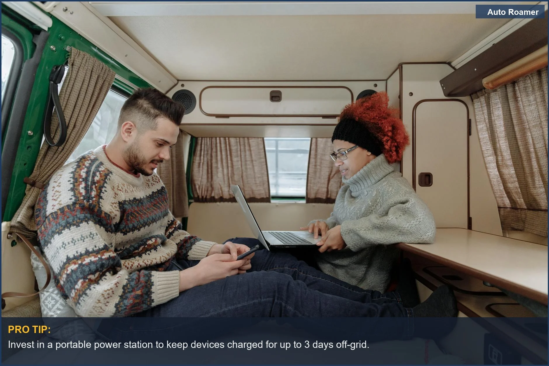 Couple using smartphone and laptop in a modern camper van, enjoying the connected digital nomad experience.