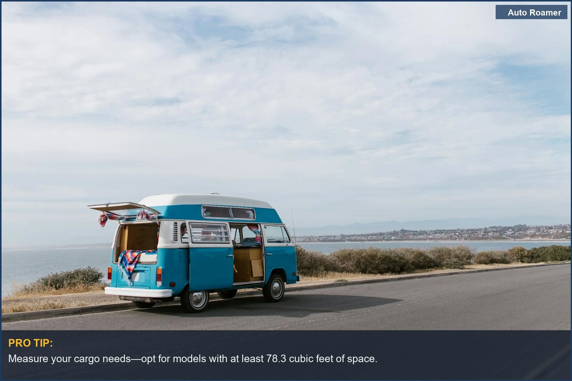 A classic blue VW camper van parked on a coastal road showcasing VW camper van dimensions.