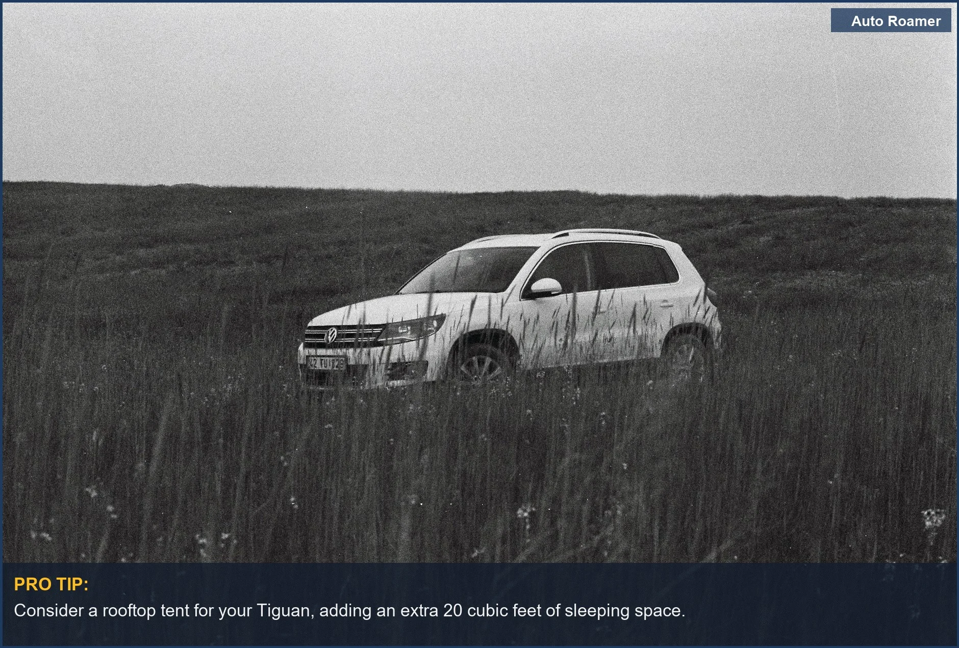 Tranquil rural landscape featuring a VW Tiguan with a rooftop tent, symbolizing exploration and freedom.