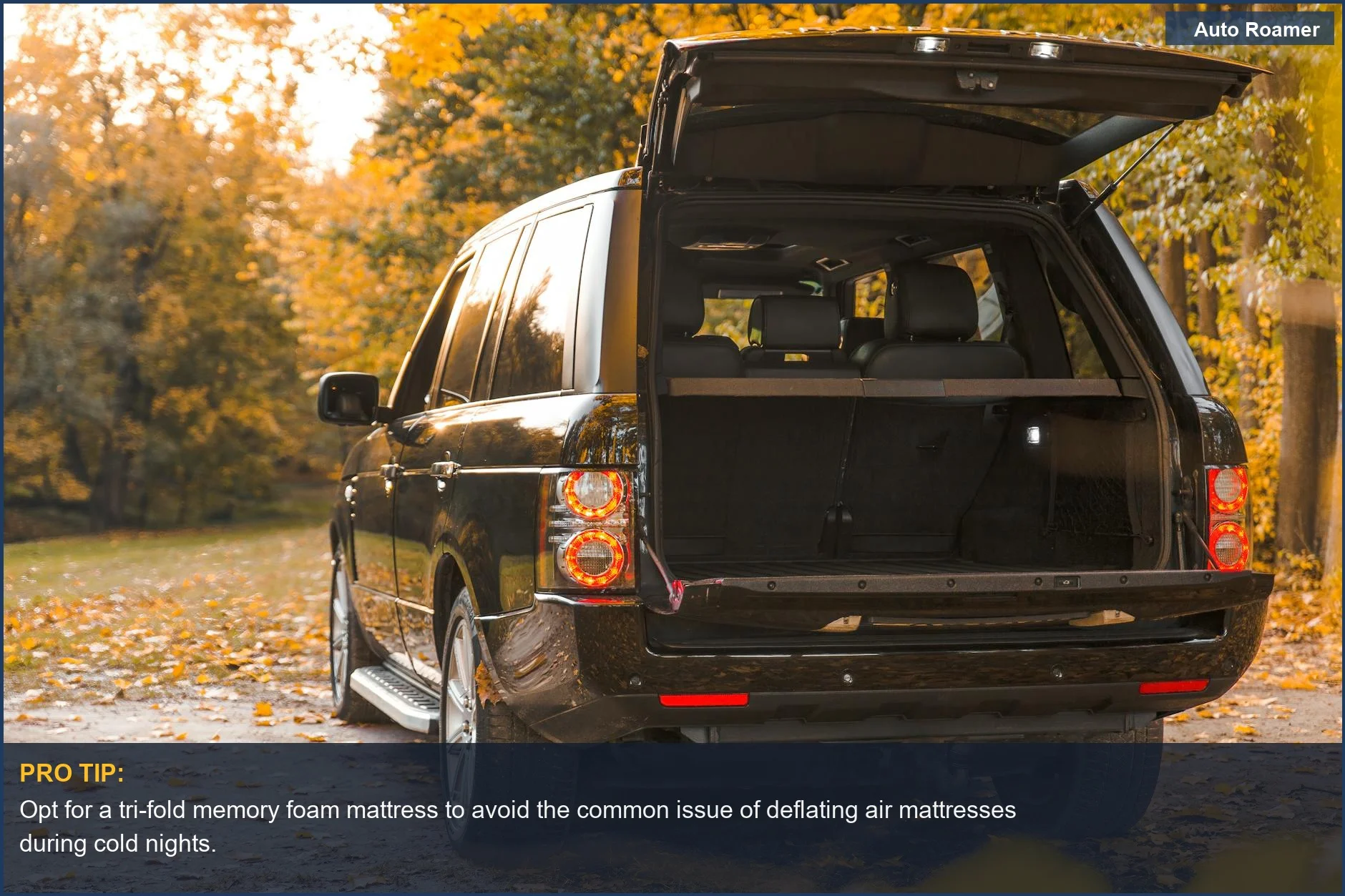 Black Volkswagen Tiguan parked on an autumn forest road with its trunk open, showcasing its camping potential.