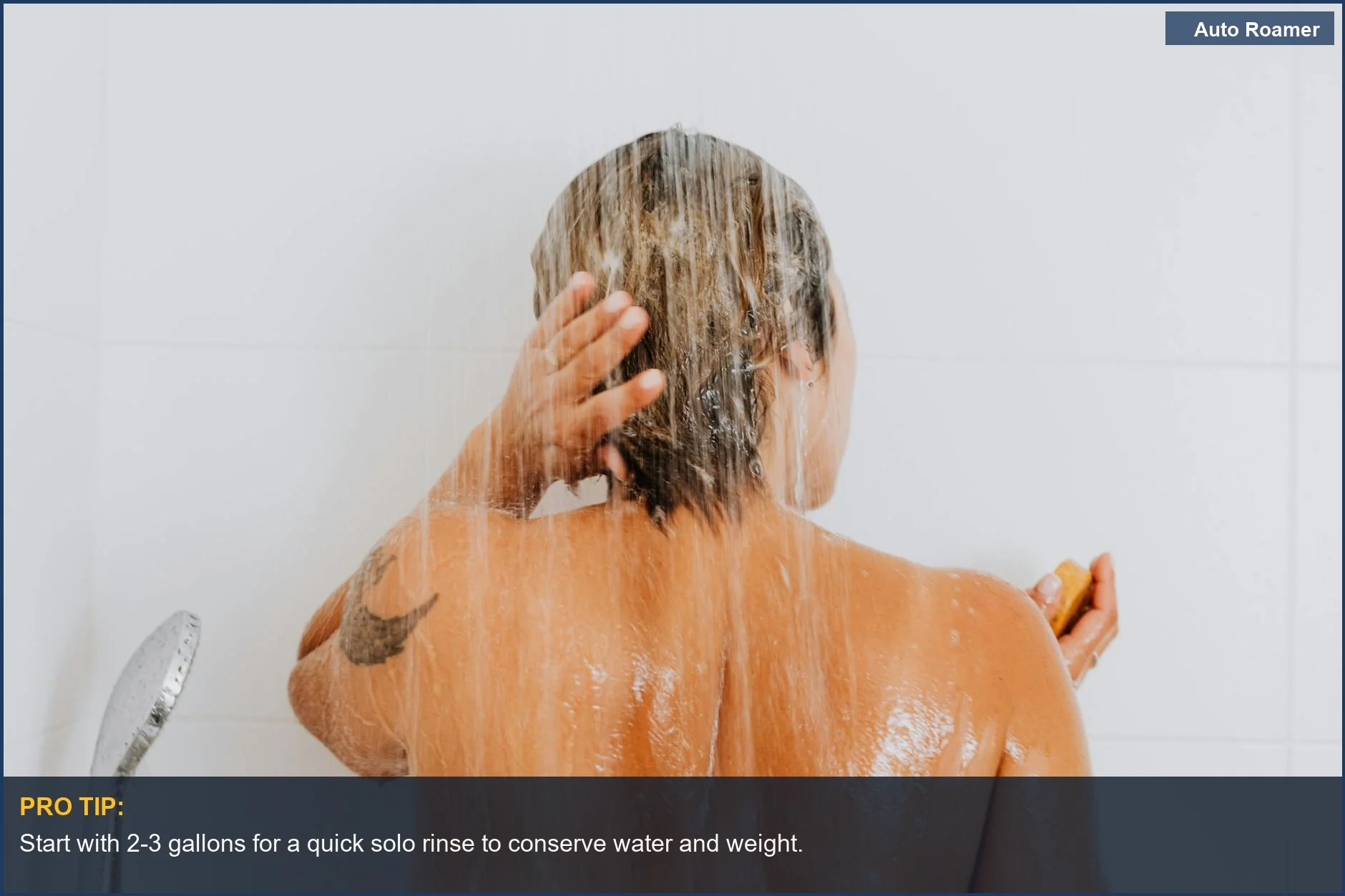 Woman rinsing hair under a portable camping shower for a refreshing wash.