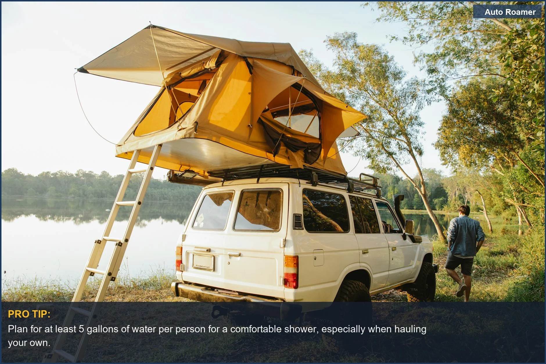 Man setting up portable car camping shower next to car and tent by a pond, considering water source.