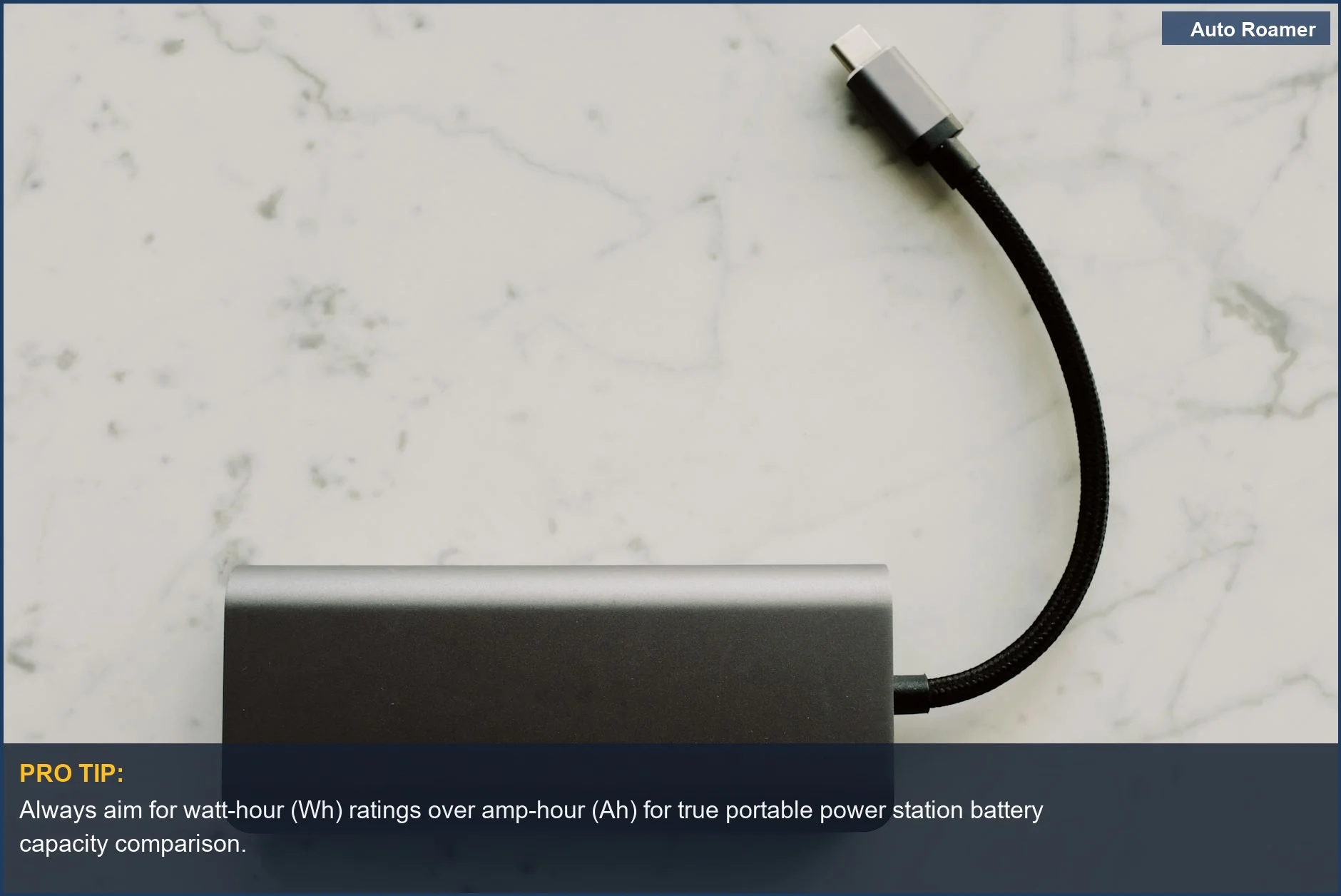 Sleek portable power station with USB-C cable, demonstrating travel tech for overlanding power needs.