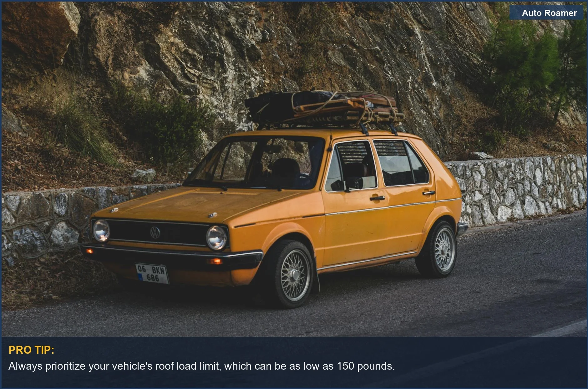 Vintage yellow car with luggage on roof by mountain road, illustrating cargo carrier weight capacity.