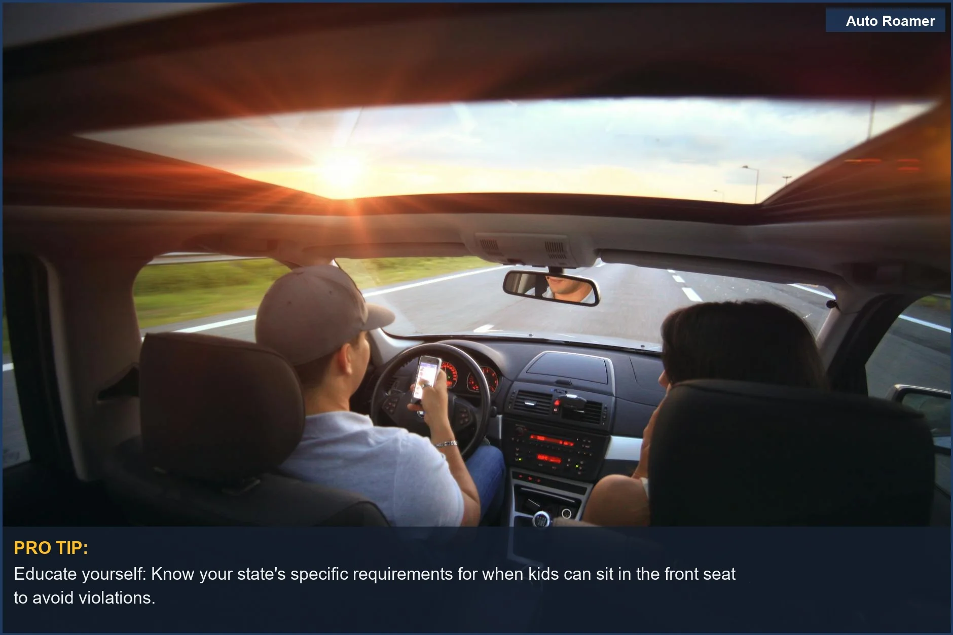 Driver using phone at sunset with passenger, a dangerous scenario related to front seat age by state.