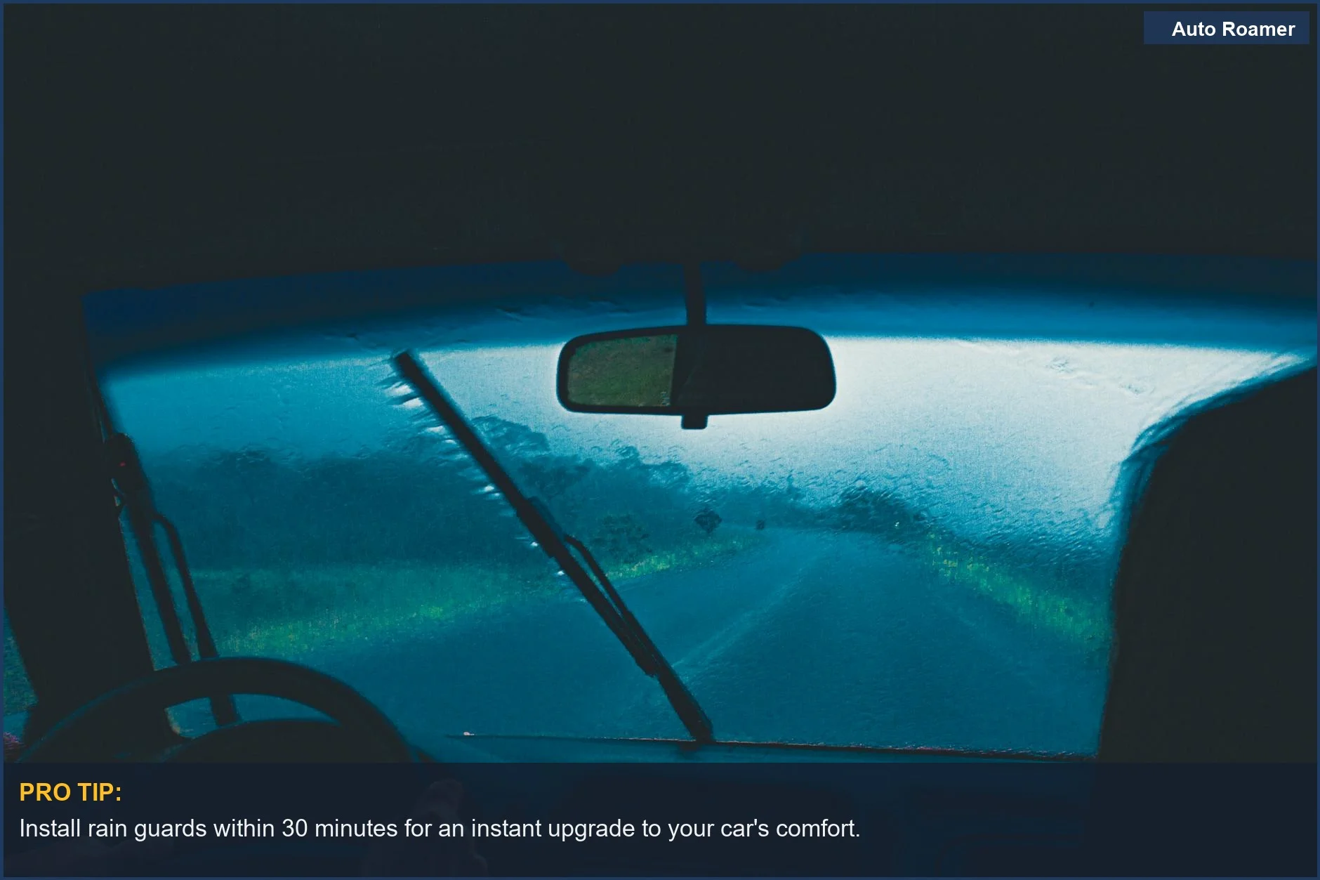 View from inside a car during rain, focusing on the wet windshield and dim surroundings.