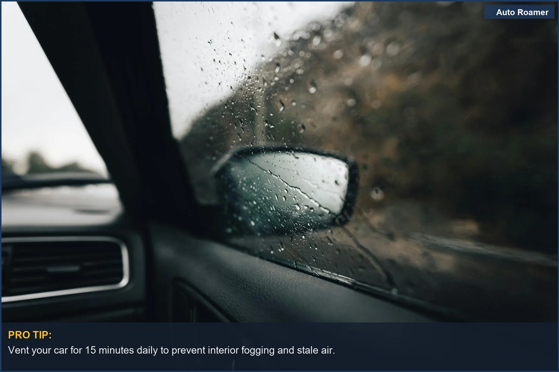 Interior view of a car window with raindrops, showing the side mirror and road outside.