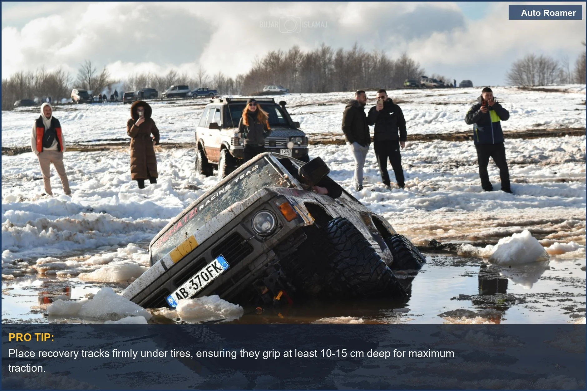 Off-road SUV stuck in muddy snow, demonstrating how recovery tracks help get unstuck.