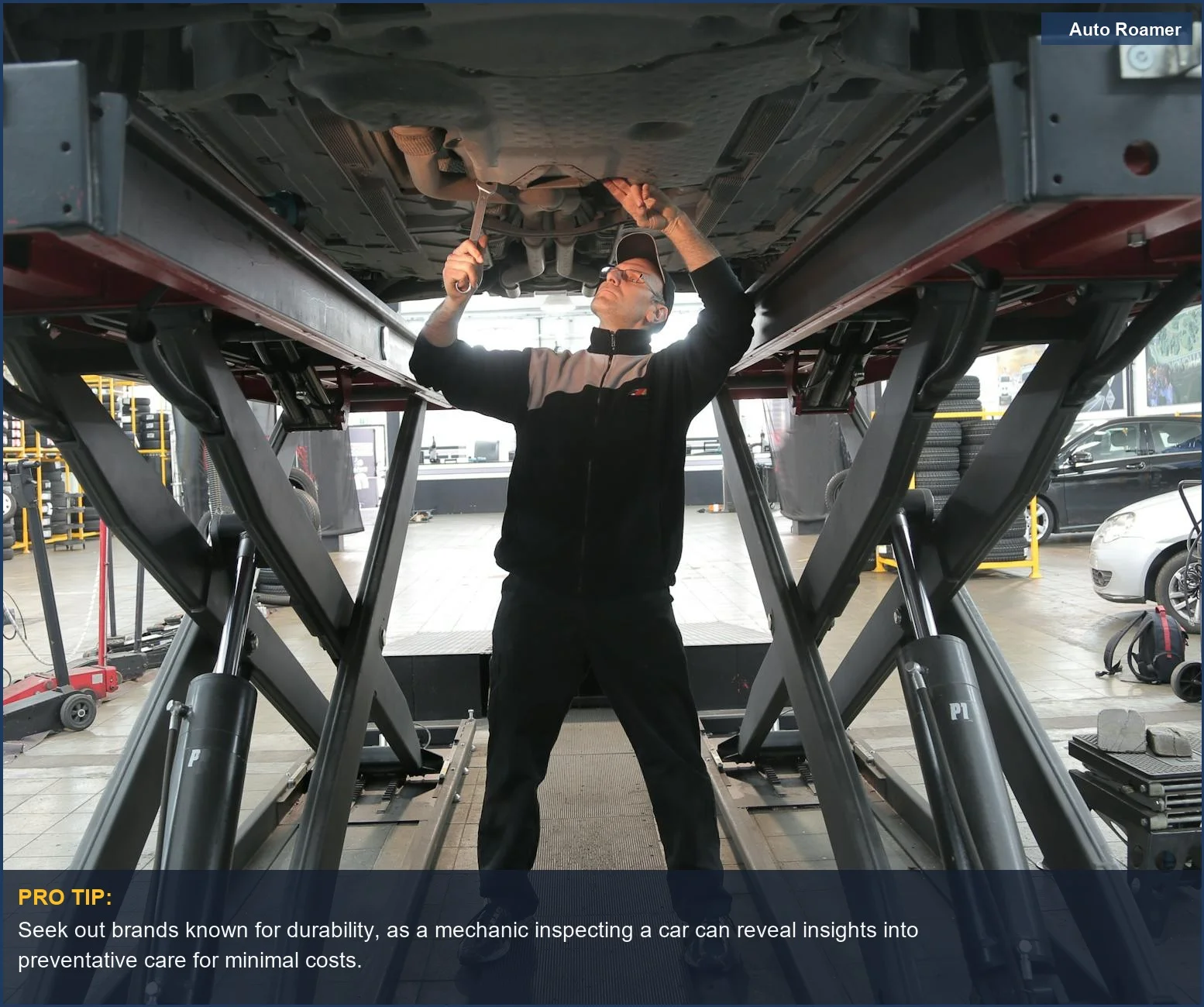Professional mechanic carefully inspecting a vehicle's engine bay in a clean, modern auto garage.