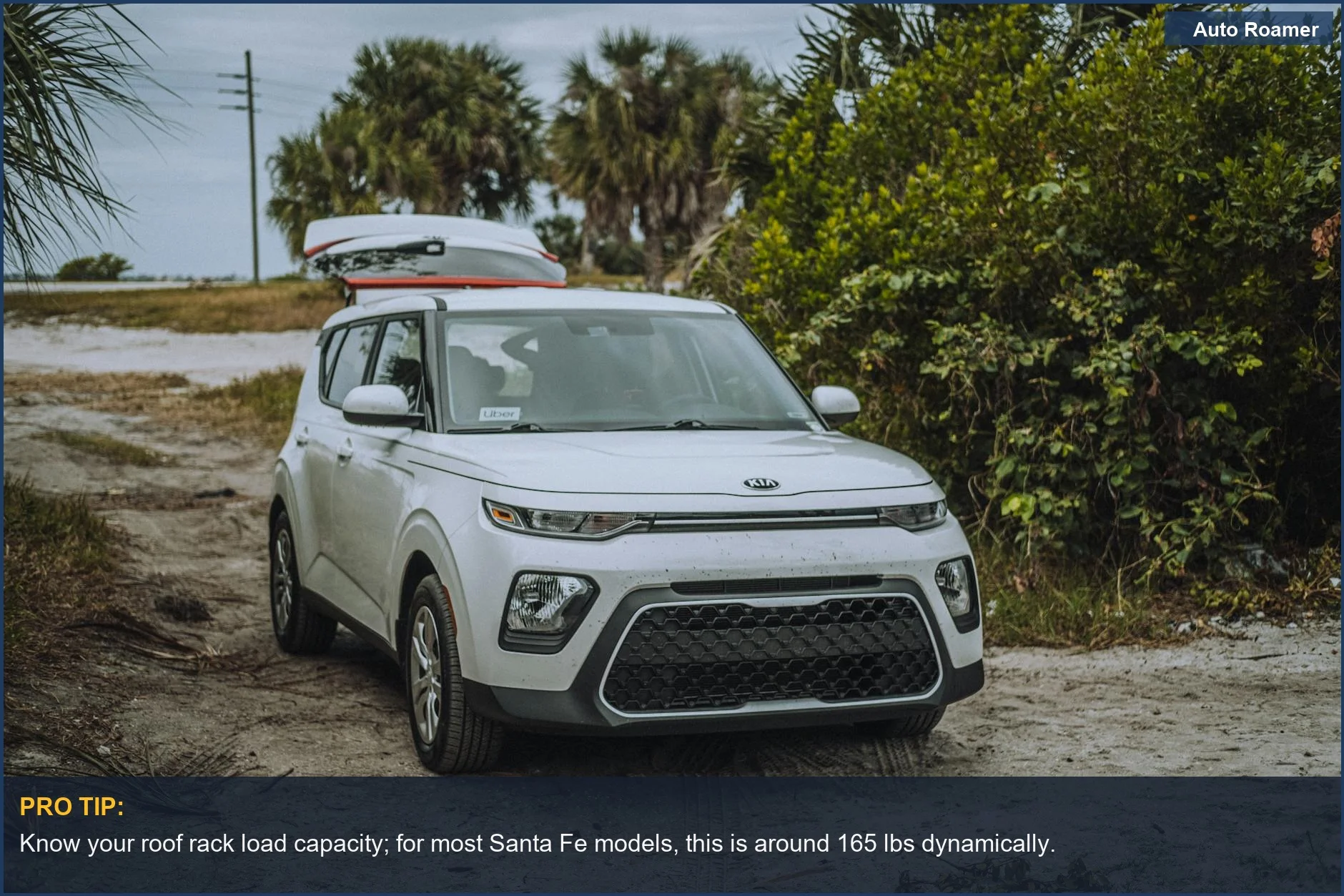 Kia Soul X-Line with roof cargo box on a scenic dirt road, ready for exploration.