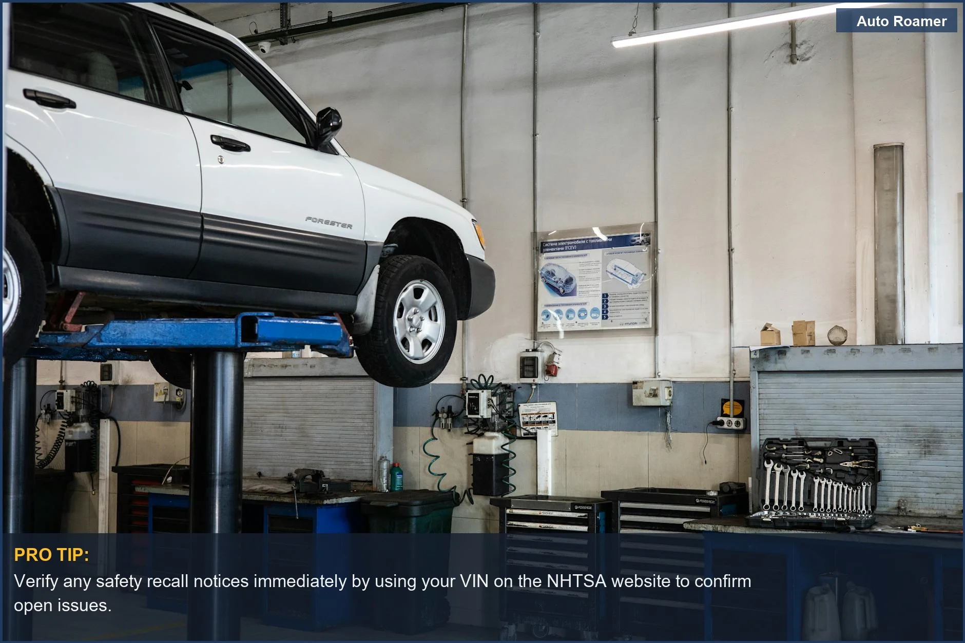 Car elevated on a lift in an auto repair shop, illustrating the process of checking for safety recalls.
