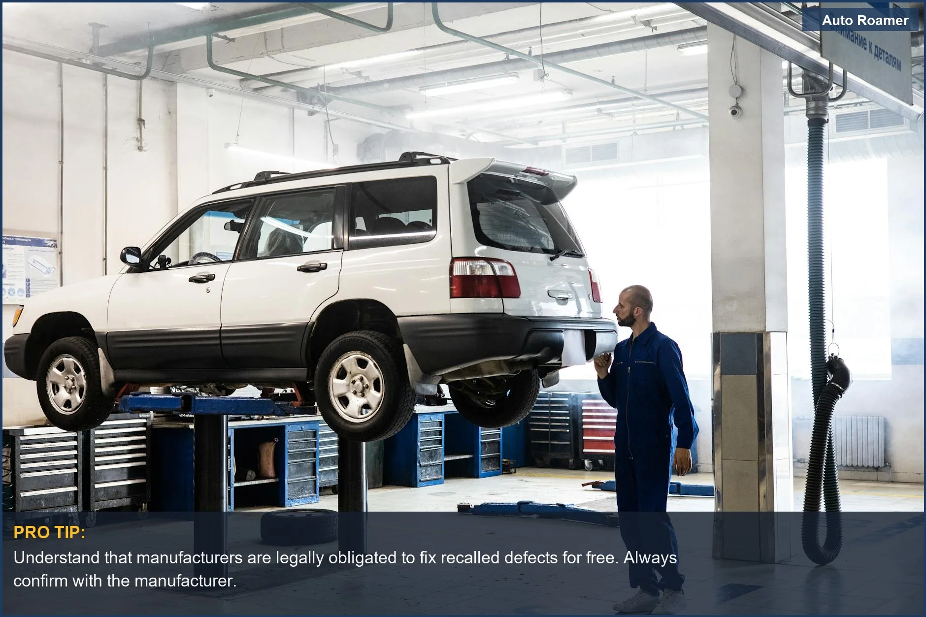 Mechanic inspecting a lifted SUV, highlighting the importance of addressing vehicle safety recall issues promptly.