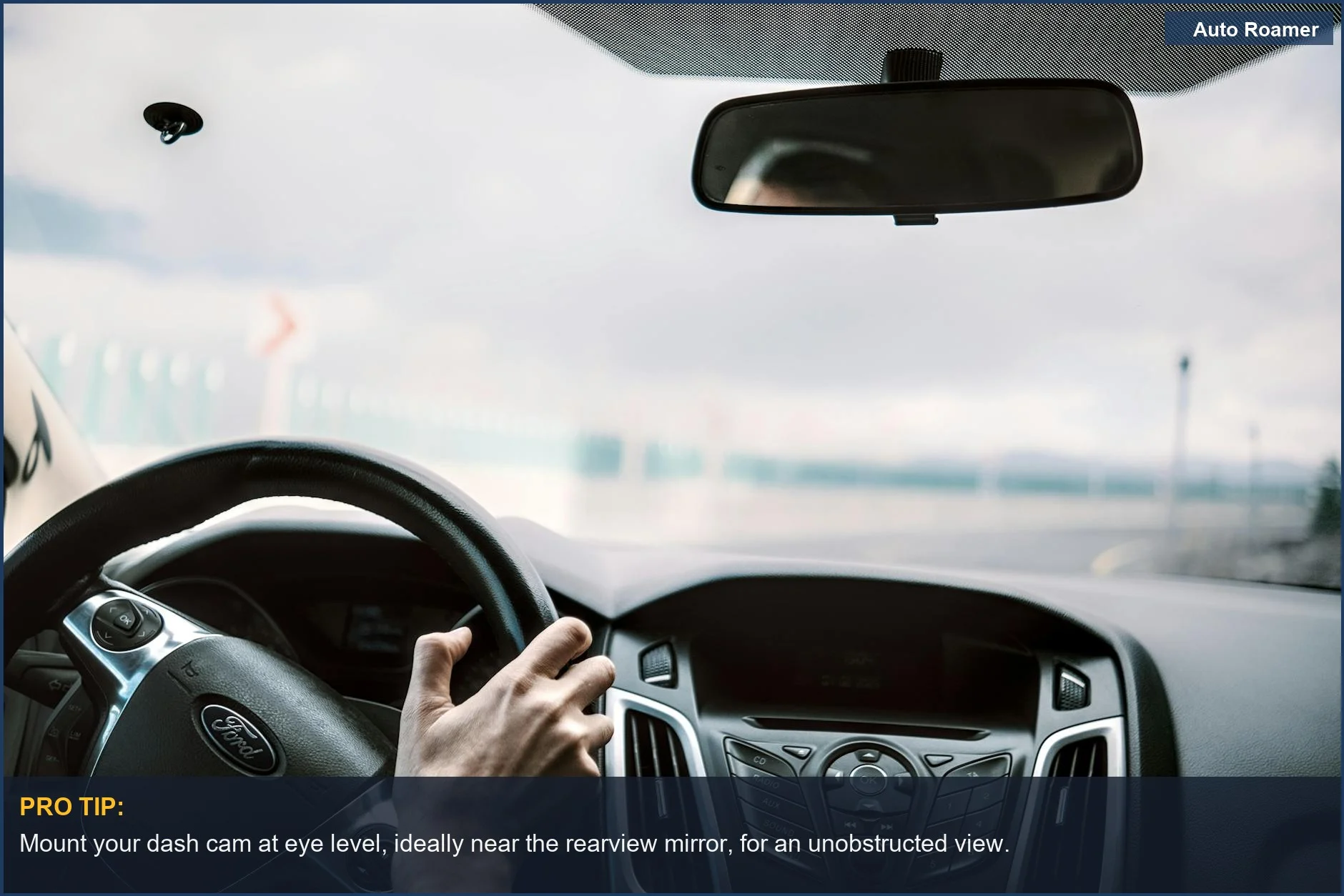View from inside a car dashboard showing steering wheel and blurred road ahead, highlighting the car camera purpose.