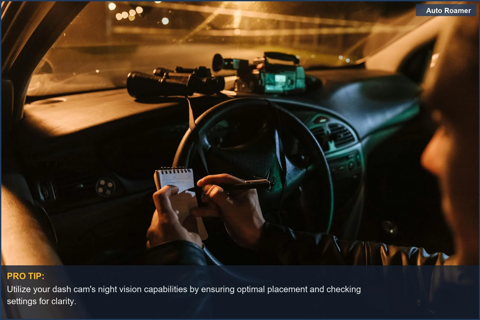 Person in car at night writing notes with dash cam, binoculars, and camera on dashboard, demonstrating dash cam benefits.