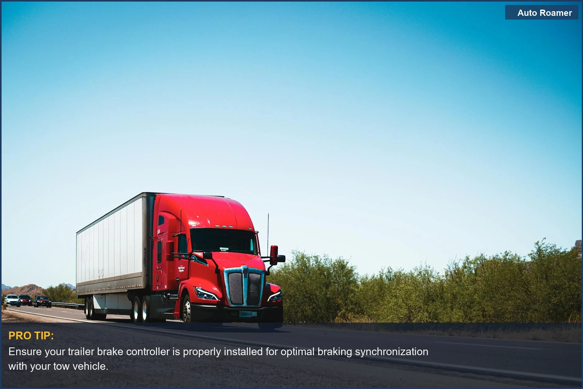 Vibrant red semi-trailer truck on a clear blue sky highway, showcasing powerful towing capabilities.