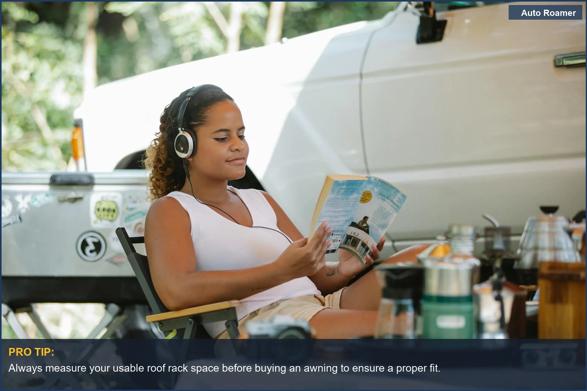 Woman with headphones enjoys car camping setup with SUV and awning.