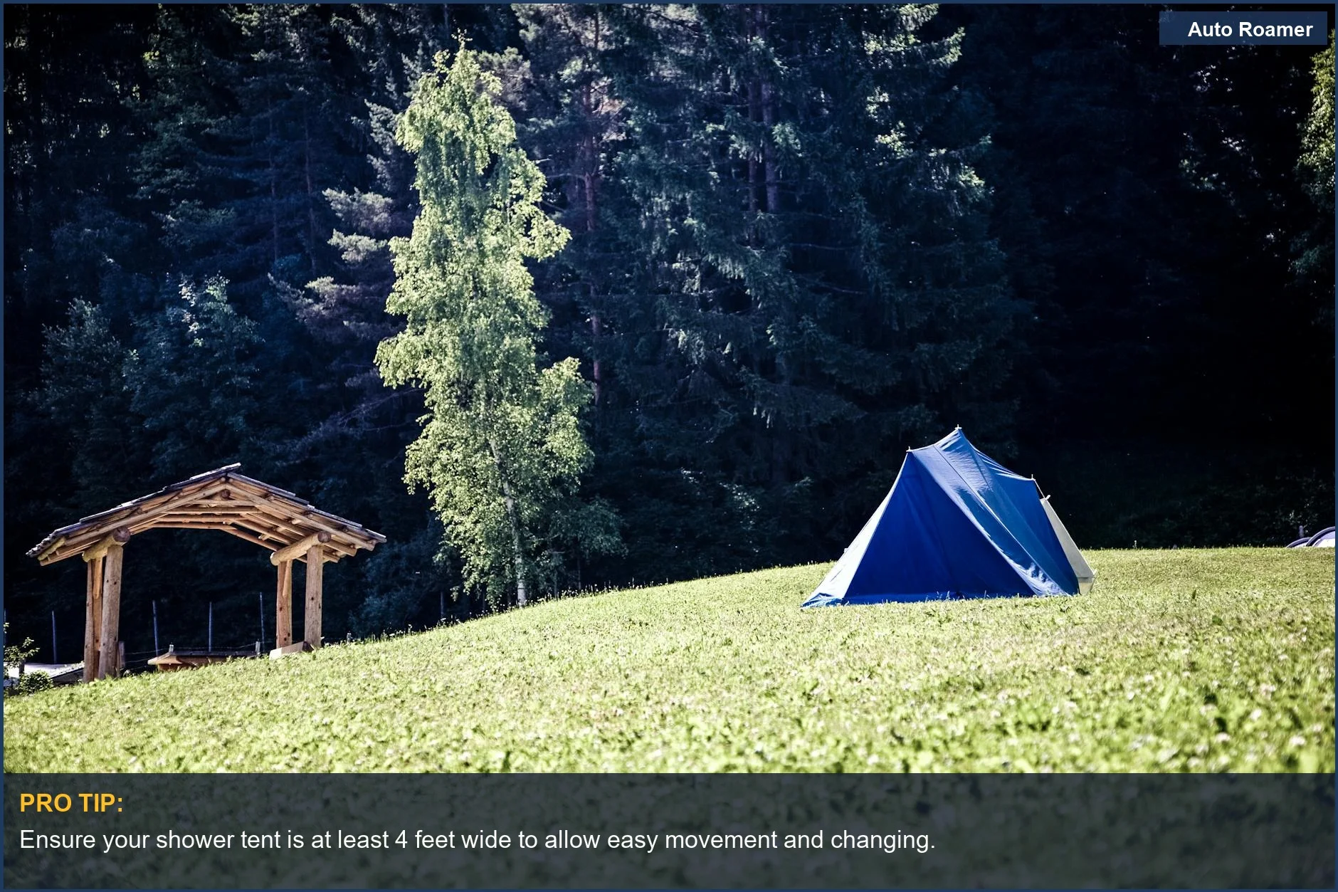 A blue camping tent in a lush forest, demonstrating how big is a shower tent for changing comfortably.