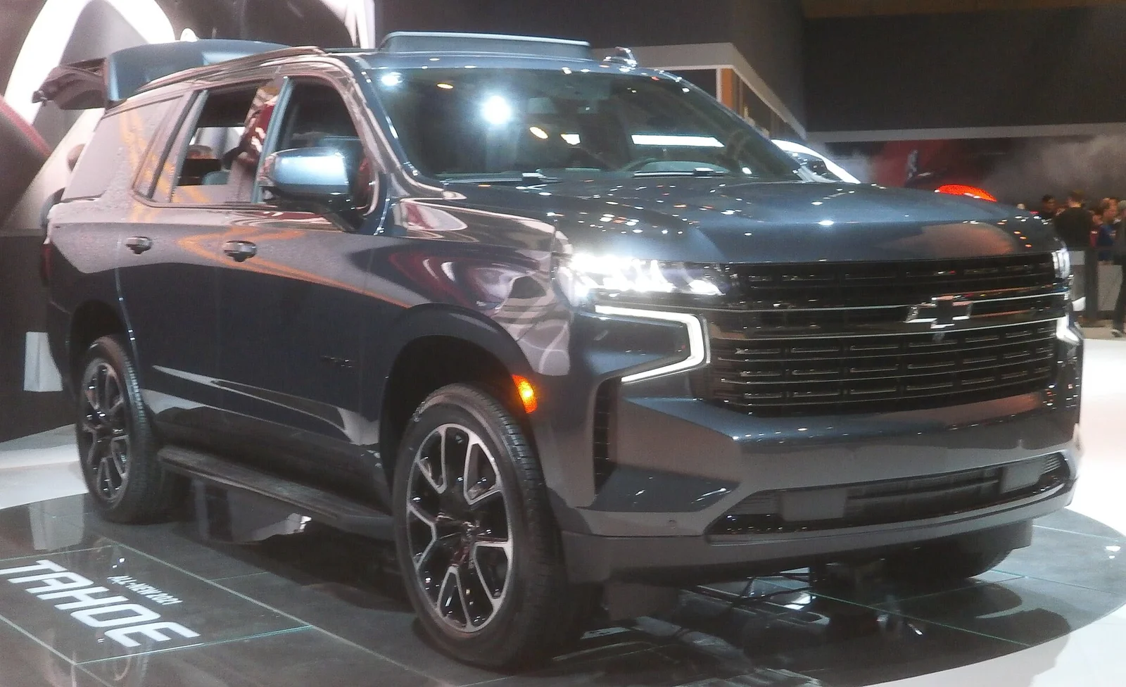 Bronze Chevy Tahoe, front three-quarter view on a street.