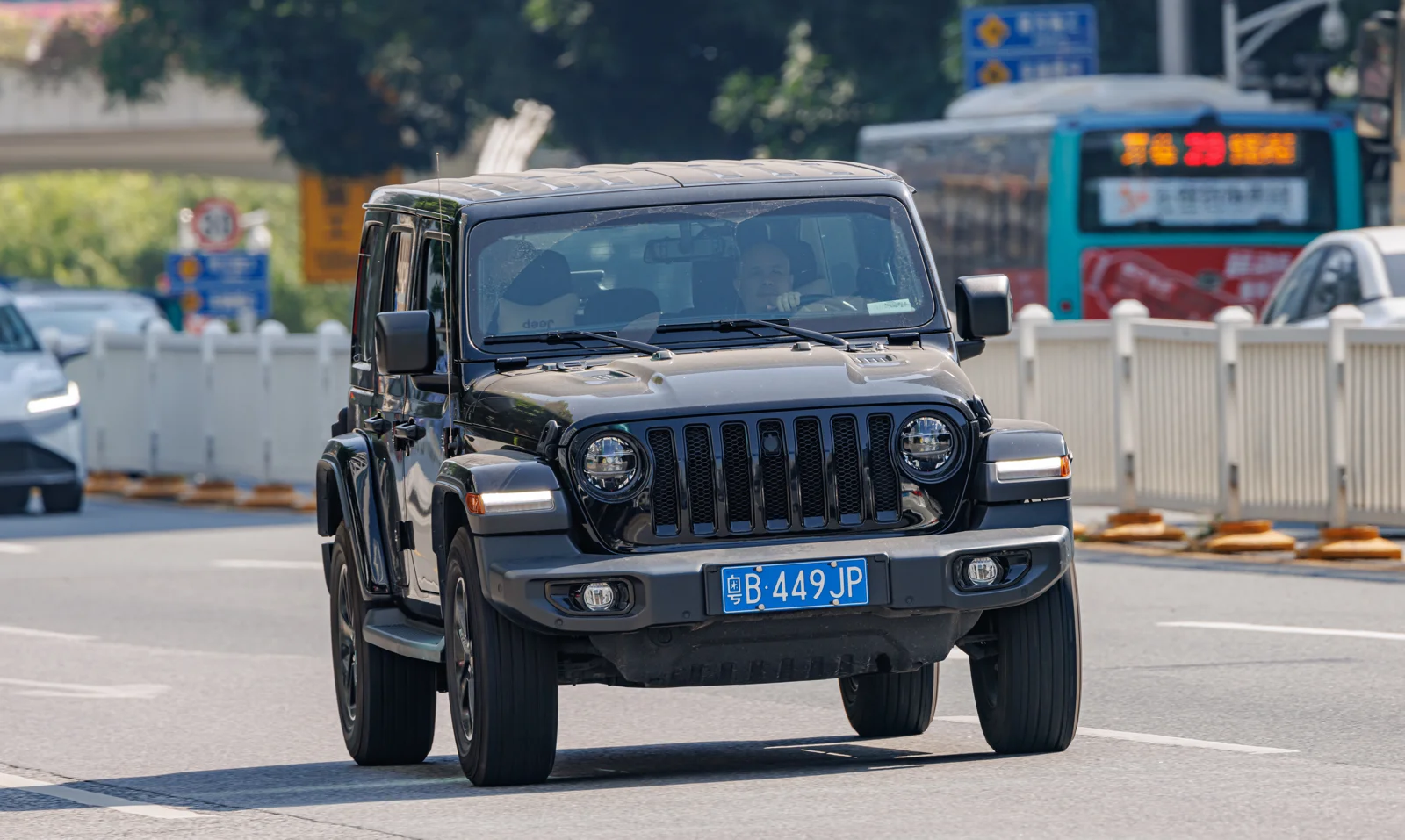 Black Jeep Wrangler Unlimited, current JL generation, four-door hardtop, front three-quarter view.