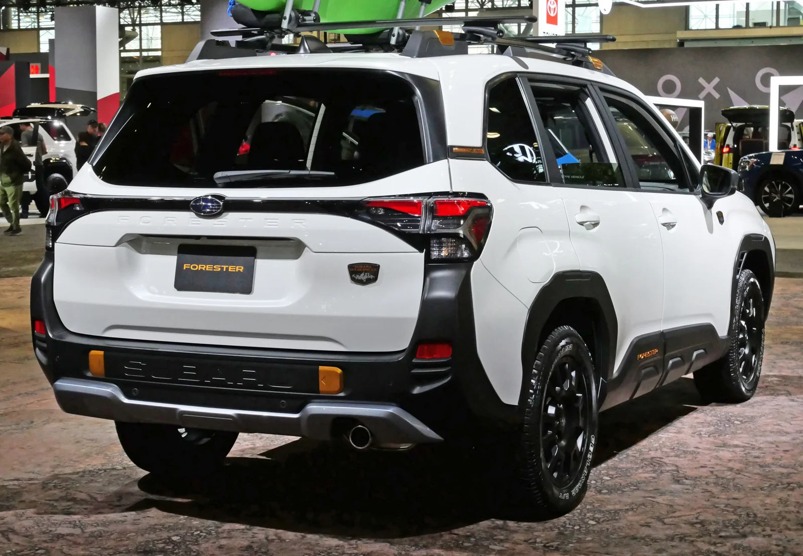 White Subaru Forester Wilderness, fifth-generation SK, rear three-quarter view with a roof rack and black cladding.
