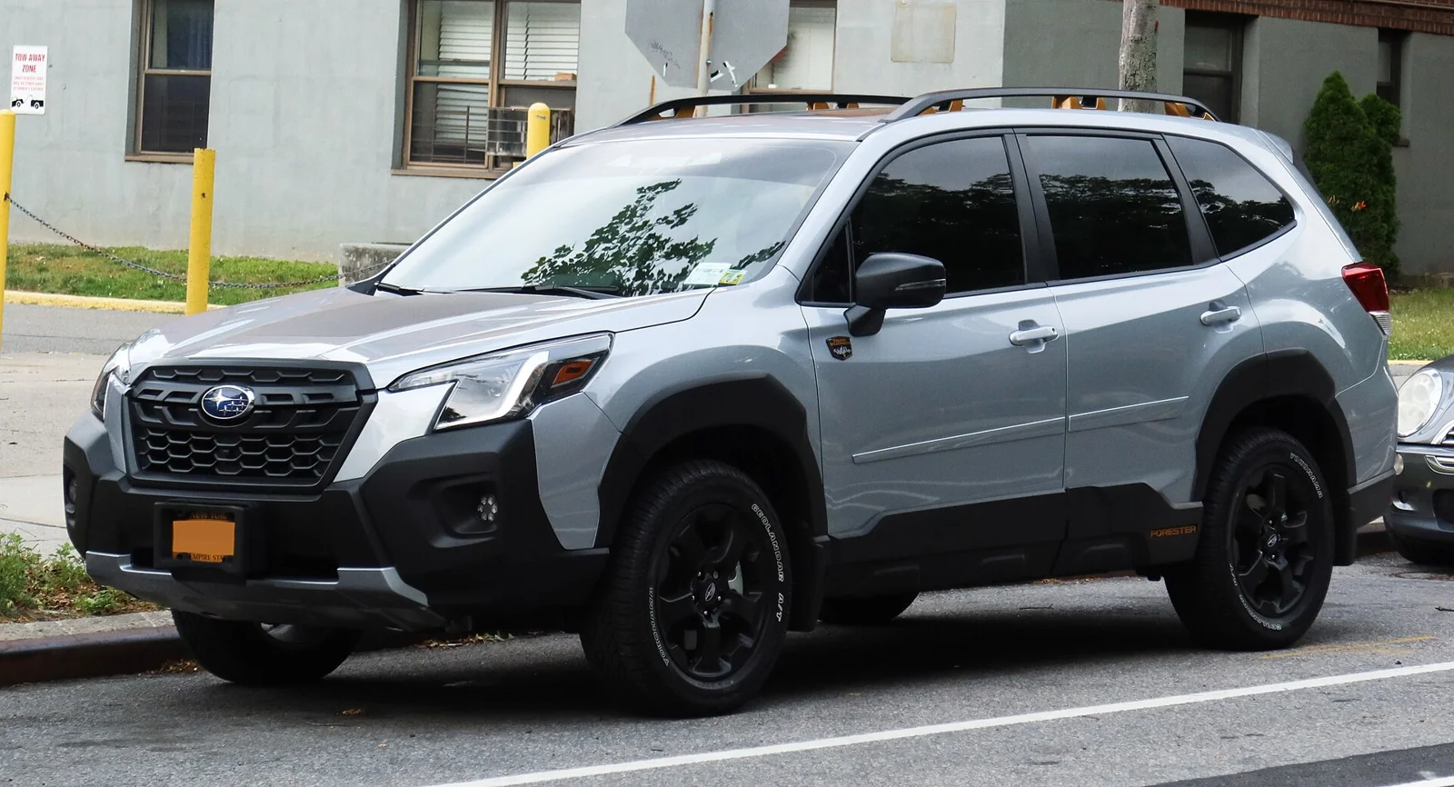 Silver Subaru Forester Wilderness, fifth-generation SK, front three-quarter view with black wheel-arch cladding.