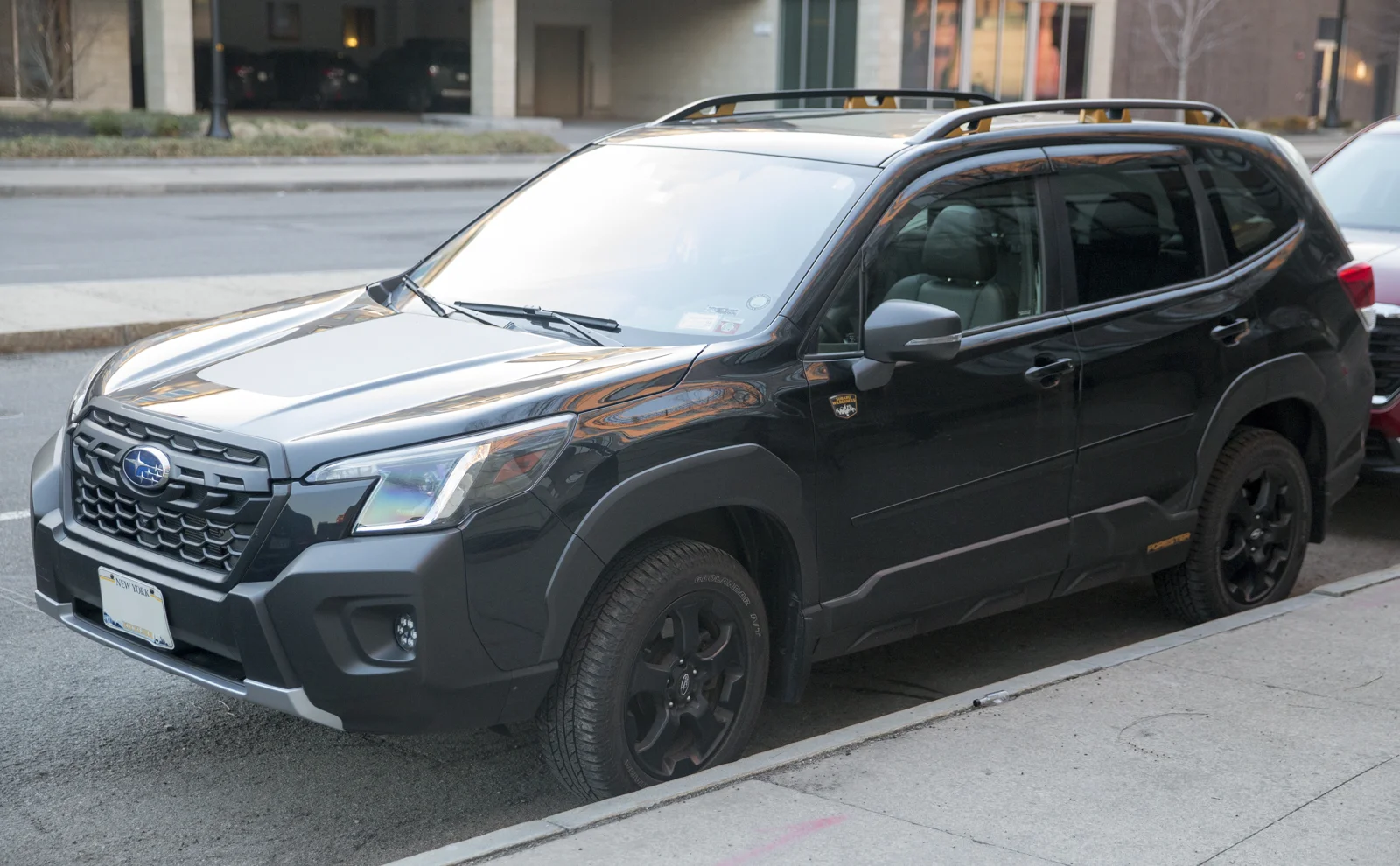 Dark-grey Subaru Forester Wilderness, fifth-generation SK, front three-quarter view in winter.