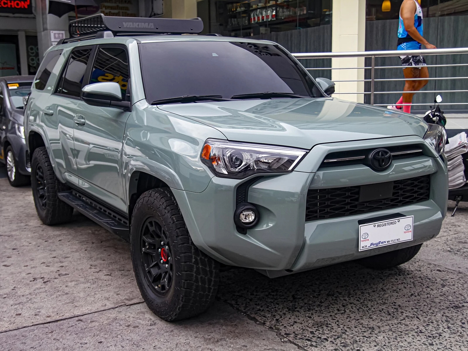 Sage-green Toyota 4Runner TRD, current sixth generation, front three-quarter view with black off-road wheels.