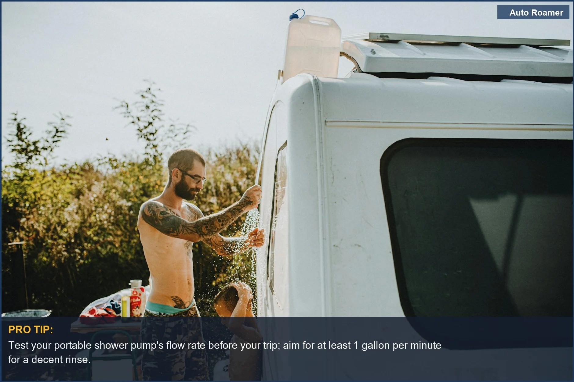 Father and son enjoying a 12v portable shower next to a campervan, highlighting car camping shower features.