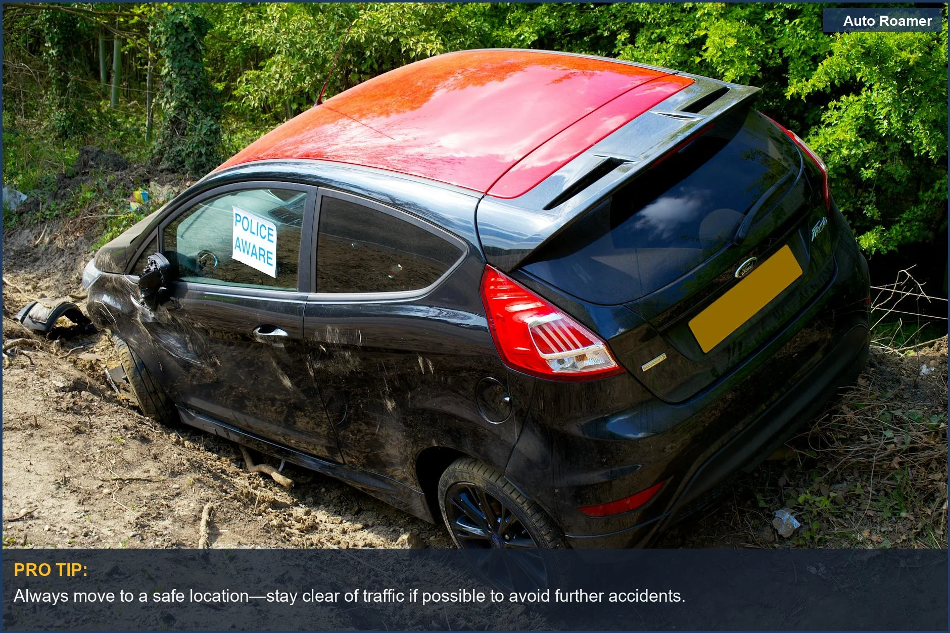 Black Ford Fiesta with a 'Police Aware' sign on a dirt road, indicating a car accident scene.