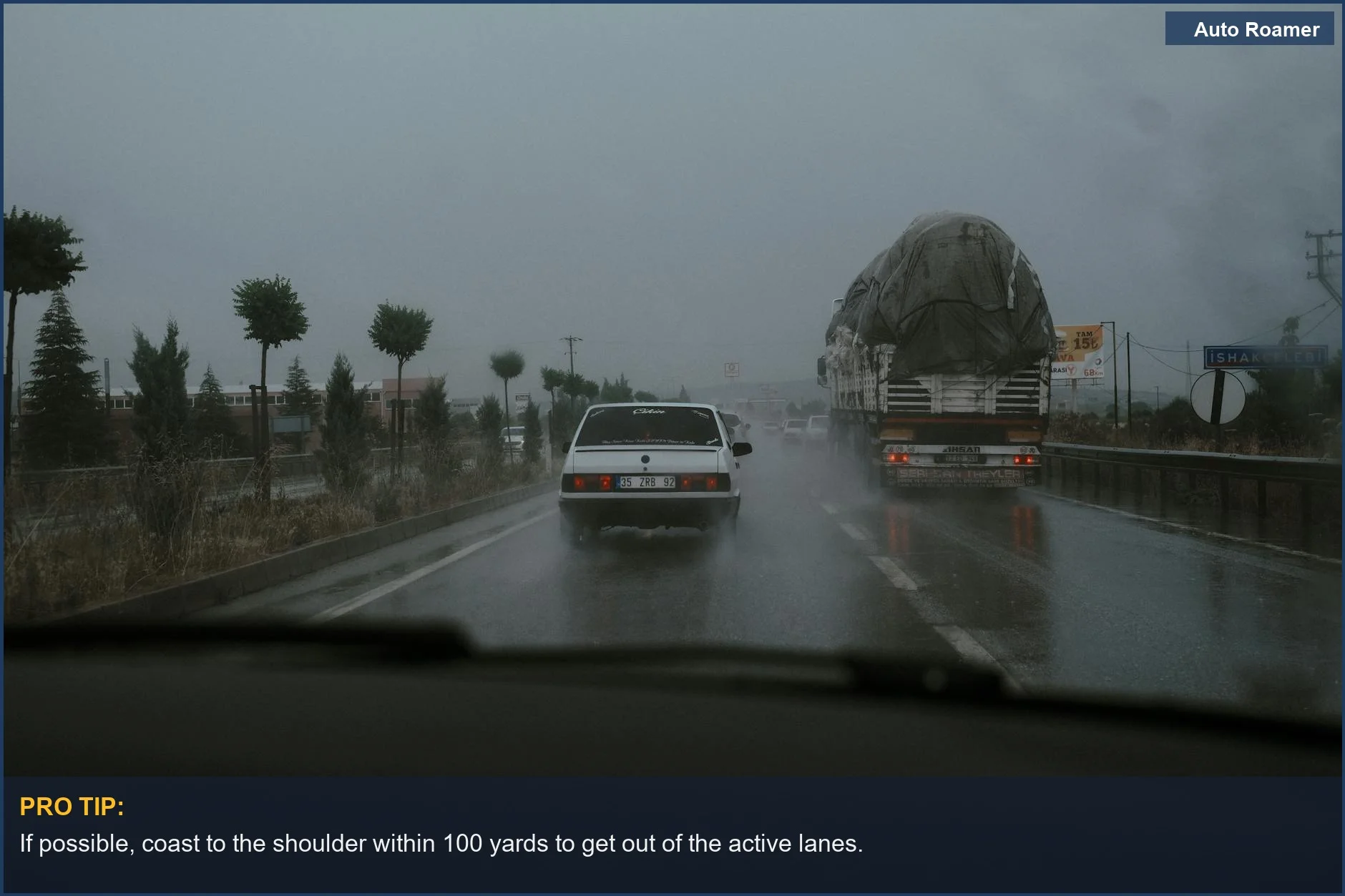 Cars driving on a wet highway during rainfall, highlighting the risks when your car stalls at high speed.