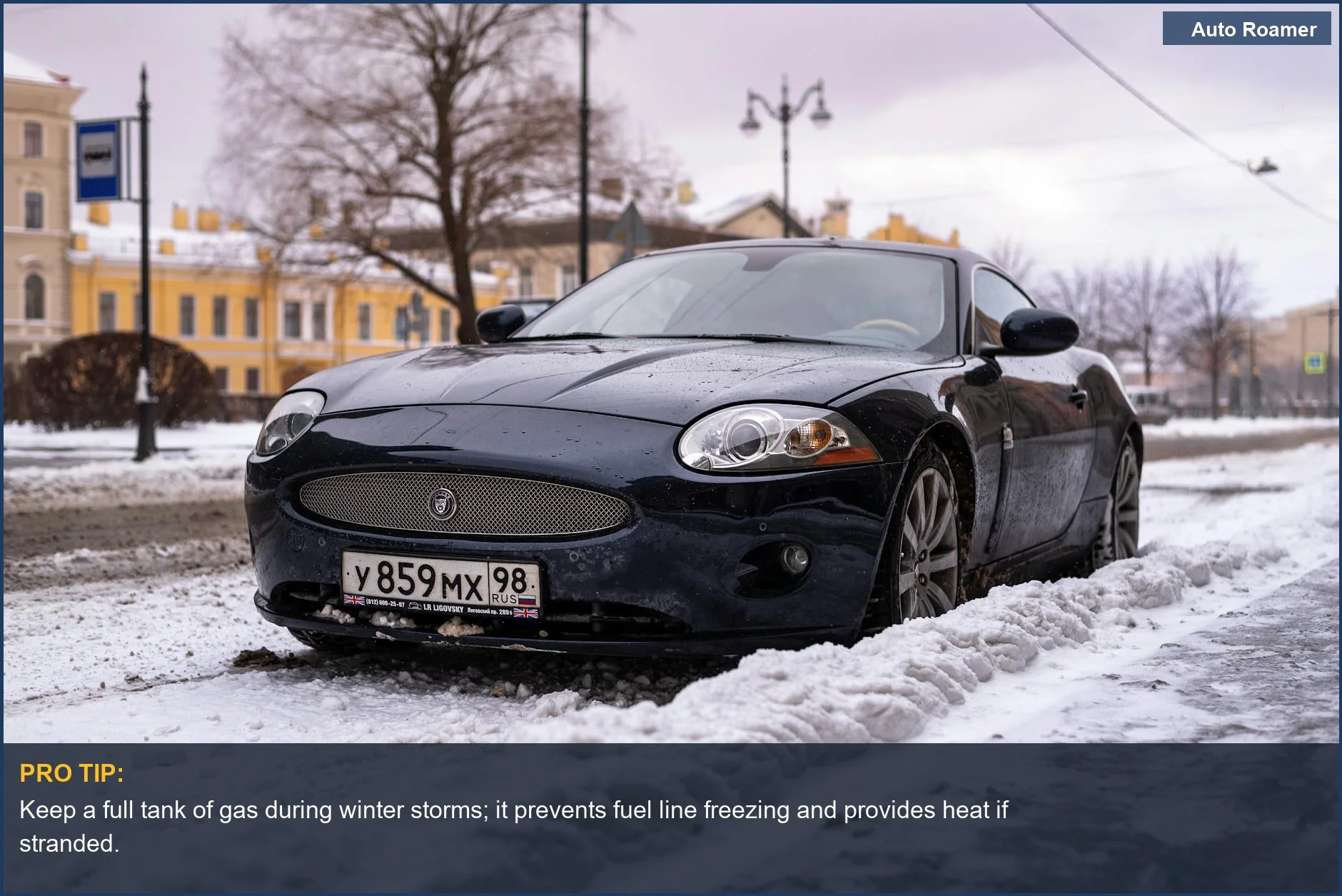 Sleek black luxury car parked on a snow-covered city street, a common sight when considering what to keep in car for winter.