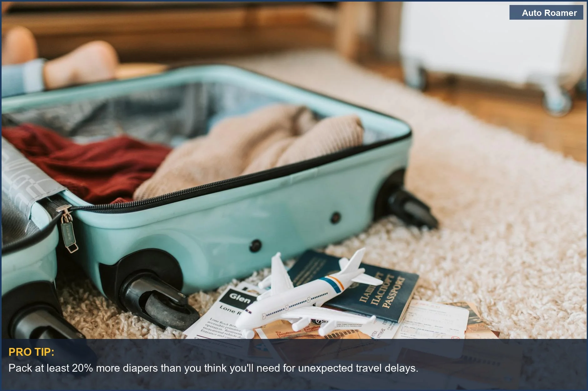 Open suitcase packed with baby travel essentials like diapers, wipes, and passport for a smooth journey.