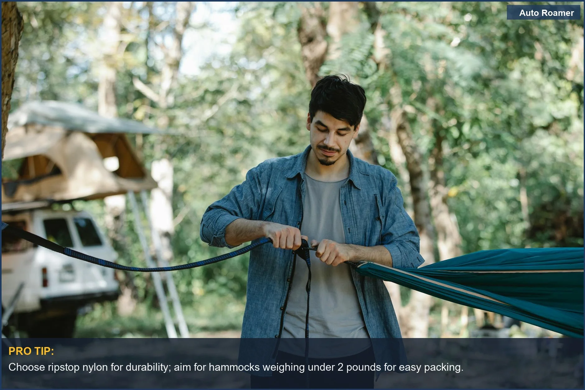 Bearded man sets up a gathered-end nylon hammock between trees, perfect for car camping adventures.