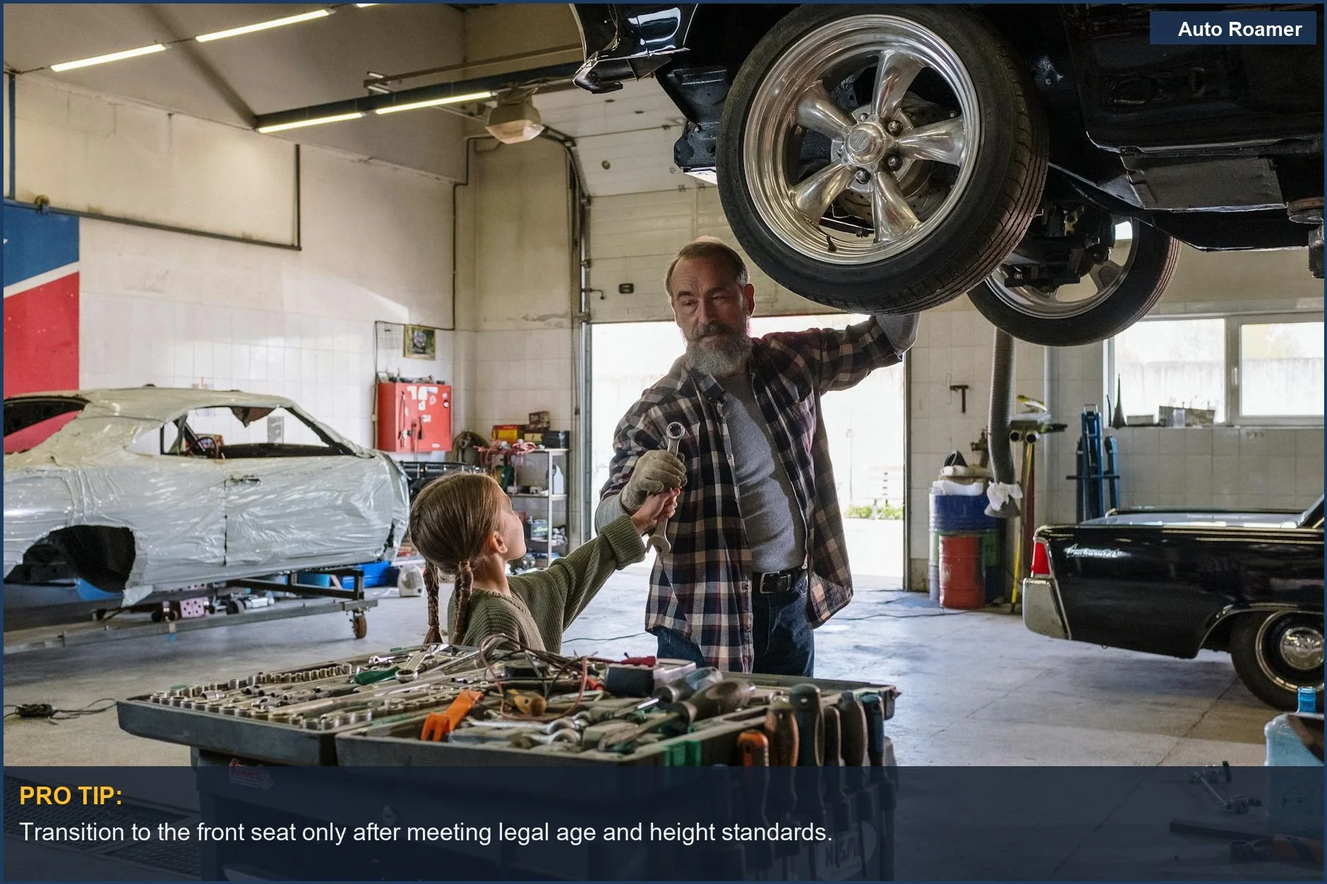 Father and daughter repairing a car, symbolizing family safety and front seat guidelines.