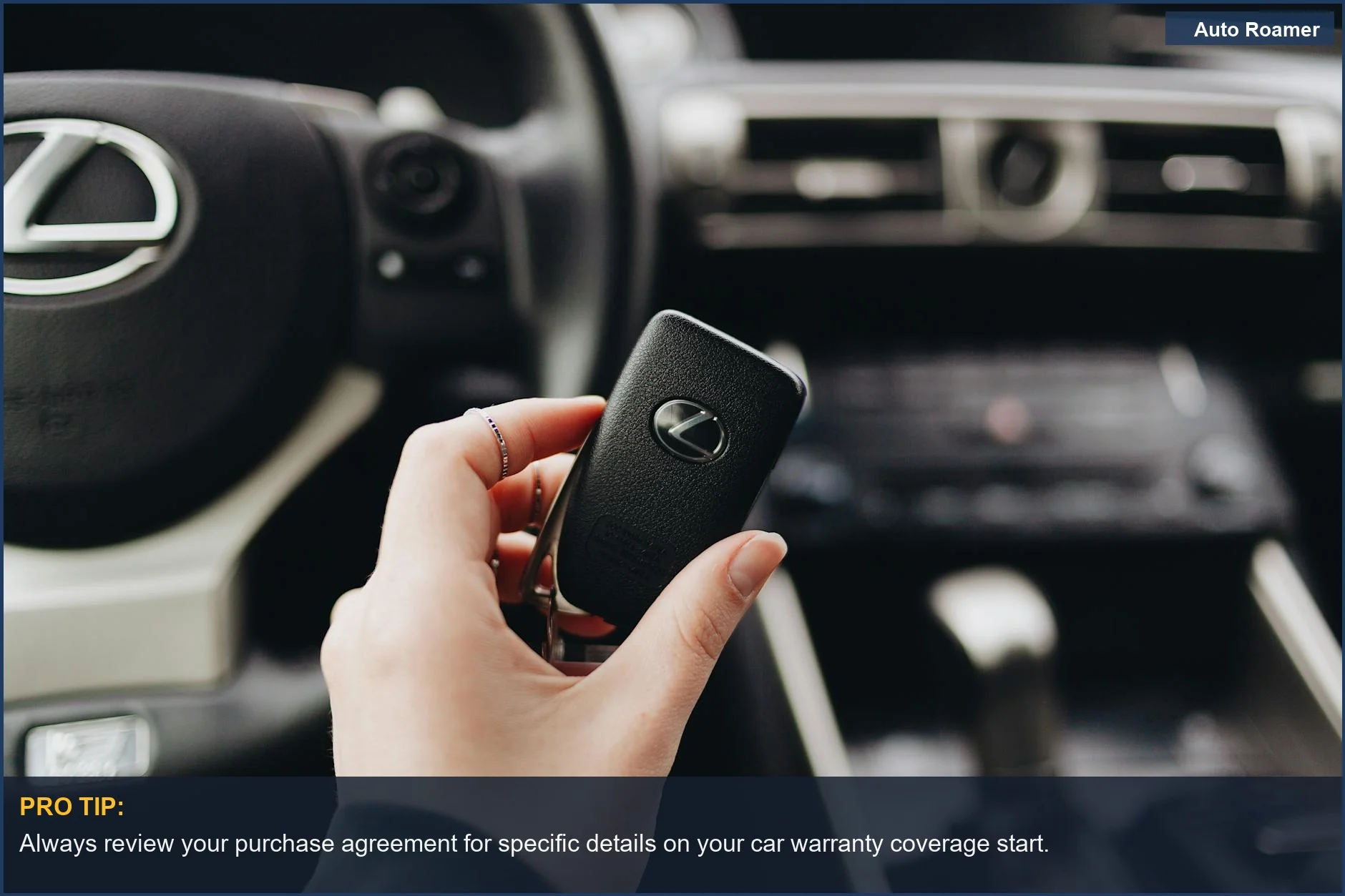 Person holding Lexus car key inside luxury vehicle interior, understanding car warranty coverage.