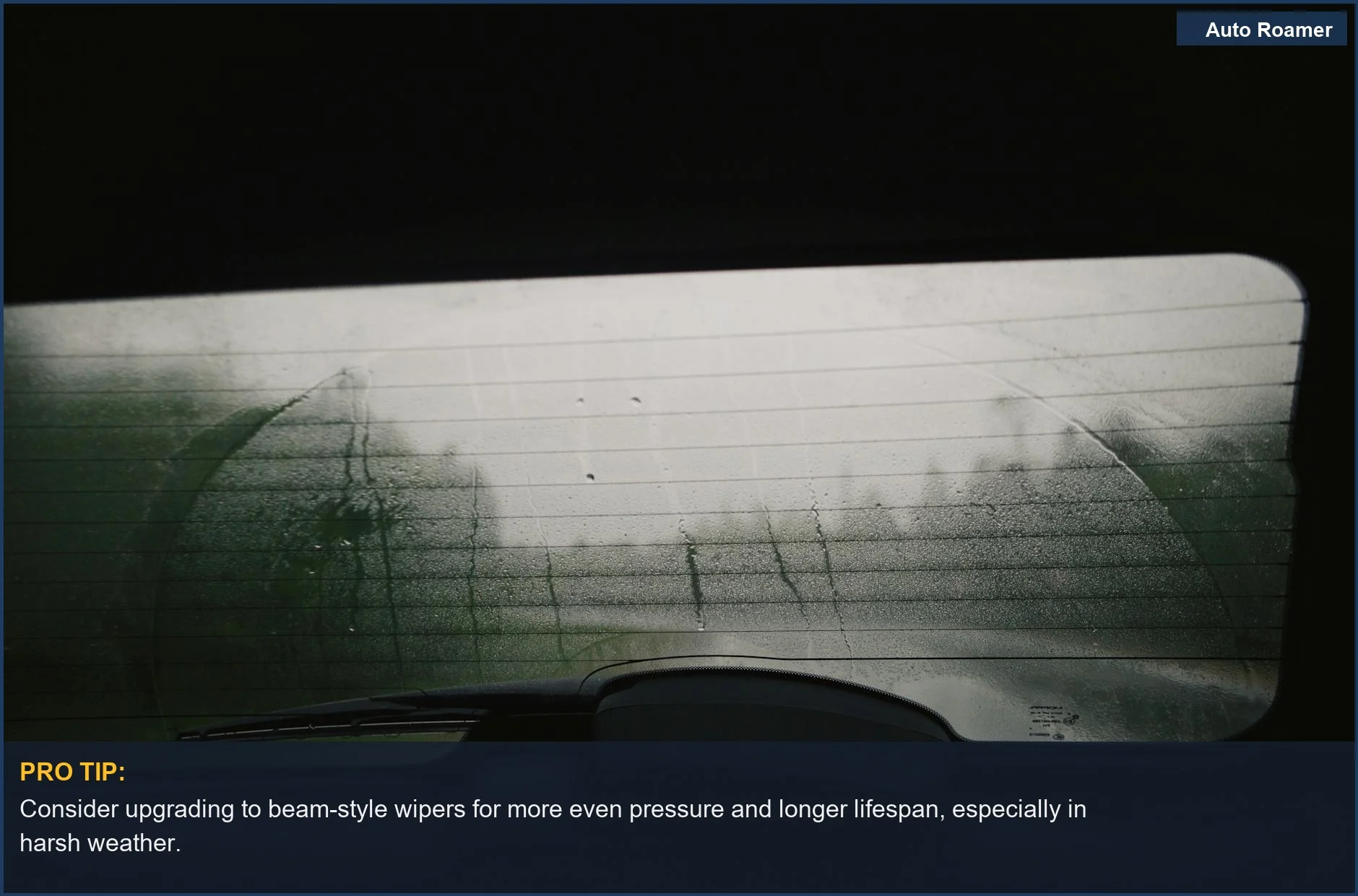 Close-up of a wet rear windshield with wiper marks, demonstrating wiper blade wear signs in a car.