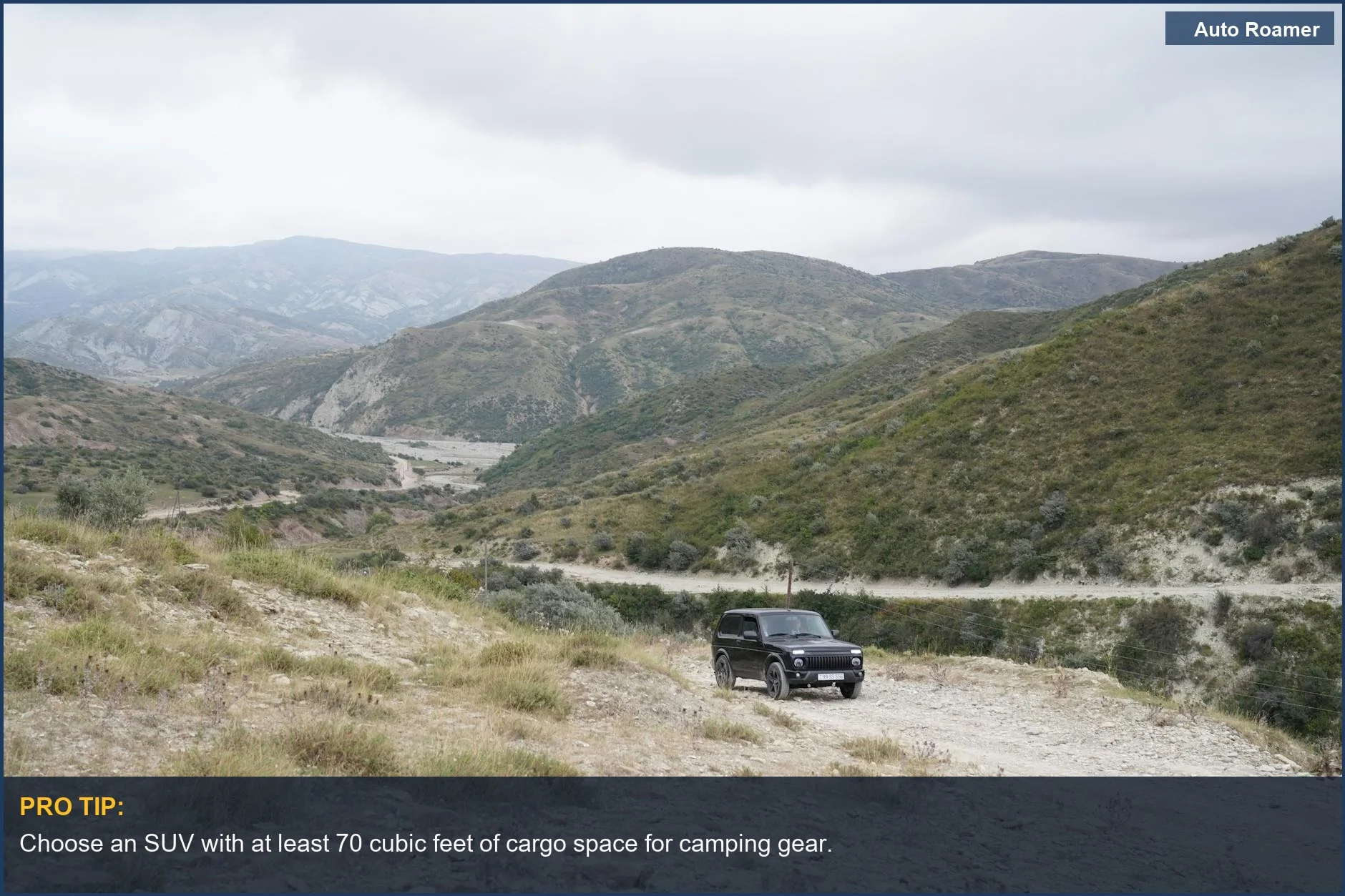 Black SUV on rugged mountain terrain, ideal for camping adventures.