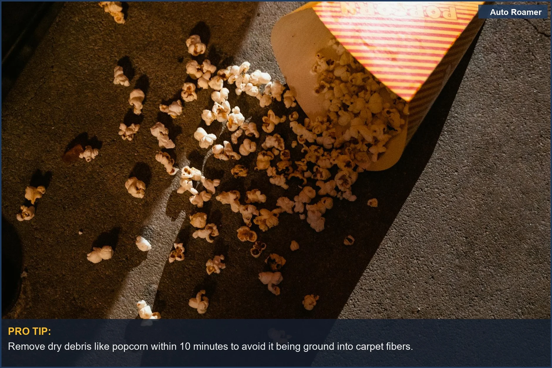 Spilled popcorn on a concrete floor, a common type of dry mess requiring car interior stain attention.