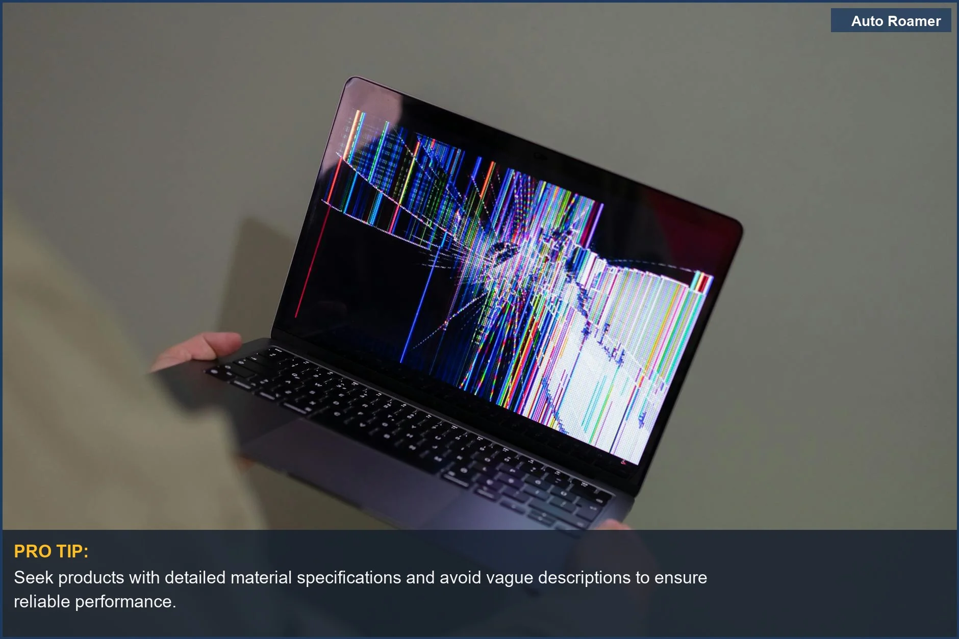 Person holding a broken laptop screen with colorful glitch, a metaphor for failing car accessories quality.