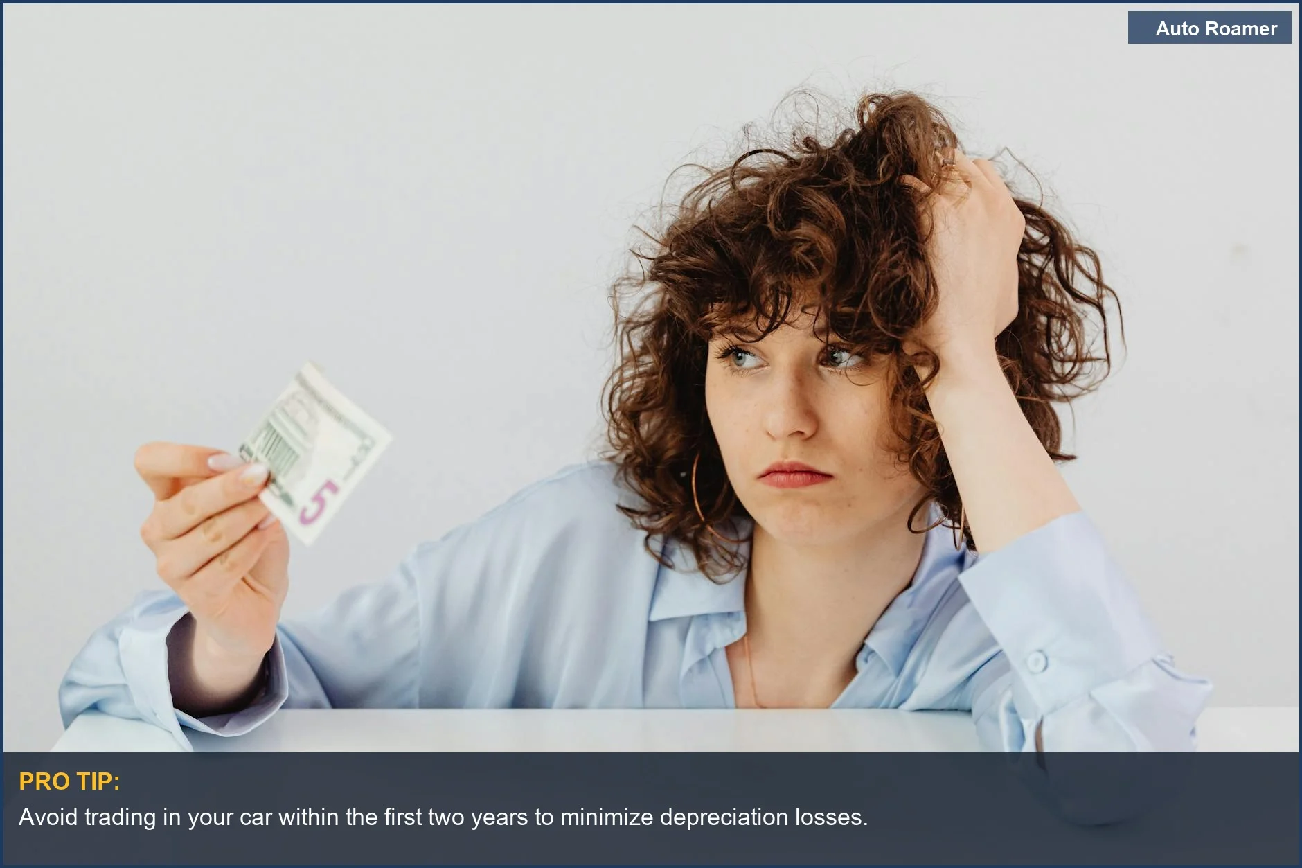 Worried woman holding a five dollar bill highlights the financial implications of early car trade-ins.