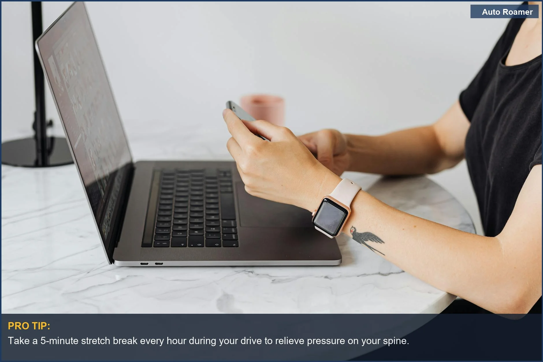 Adult working on laptop and phone indoors, illustrating the sedentary nature causing back pain after driving.