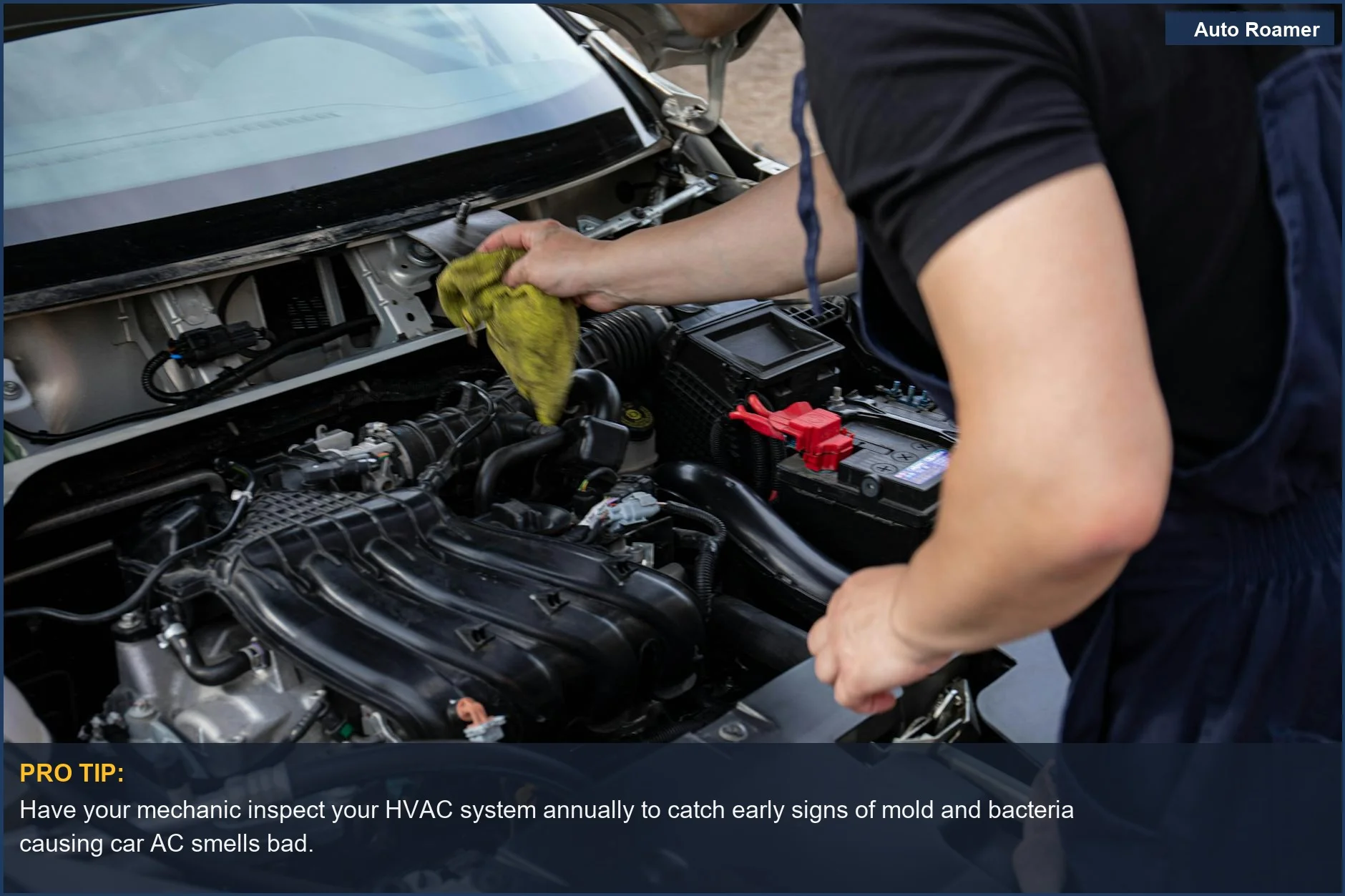 Mechanic's hands working on a car engine, symbolizing car AC smells bad due to internal system issues.