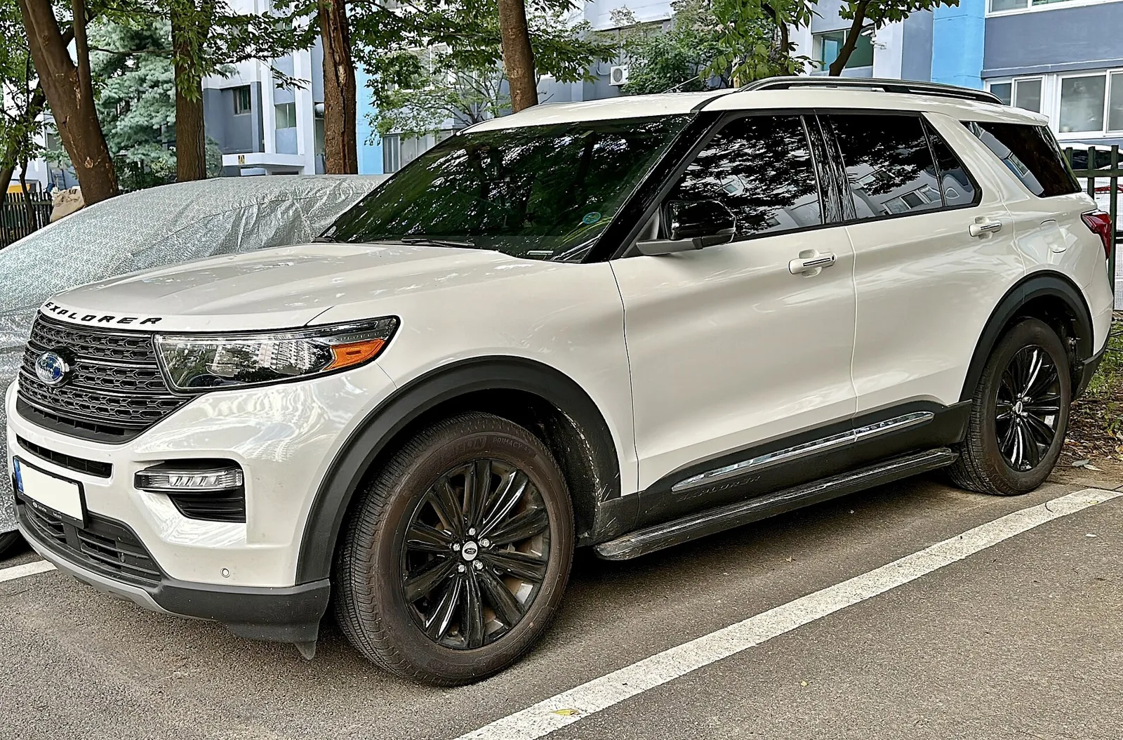 A white Ford Explorer, current sixth generation, front three-quarter view.