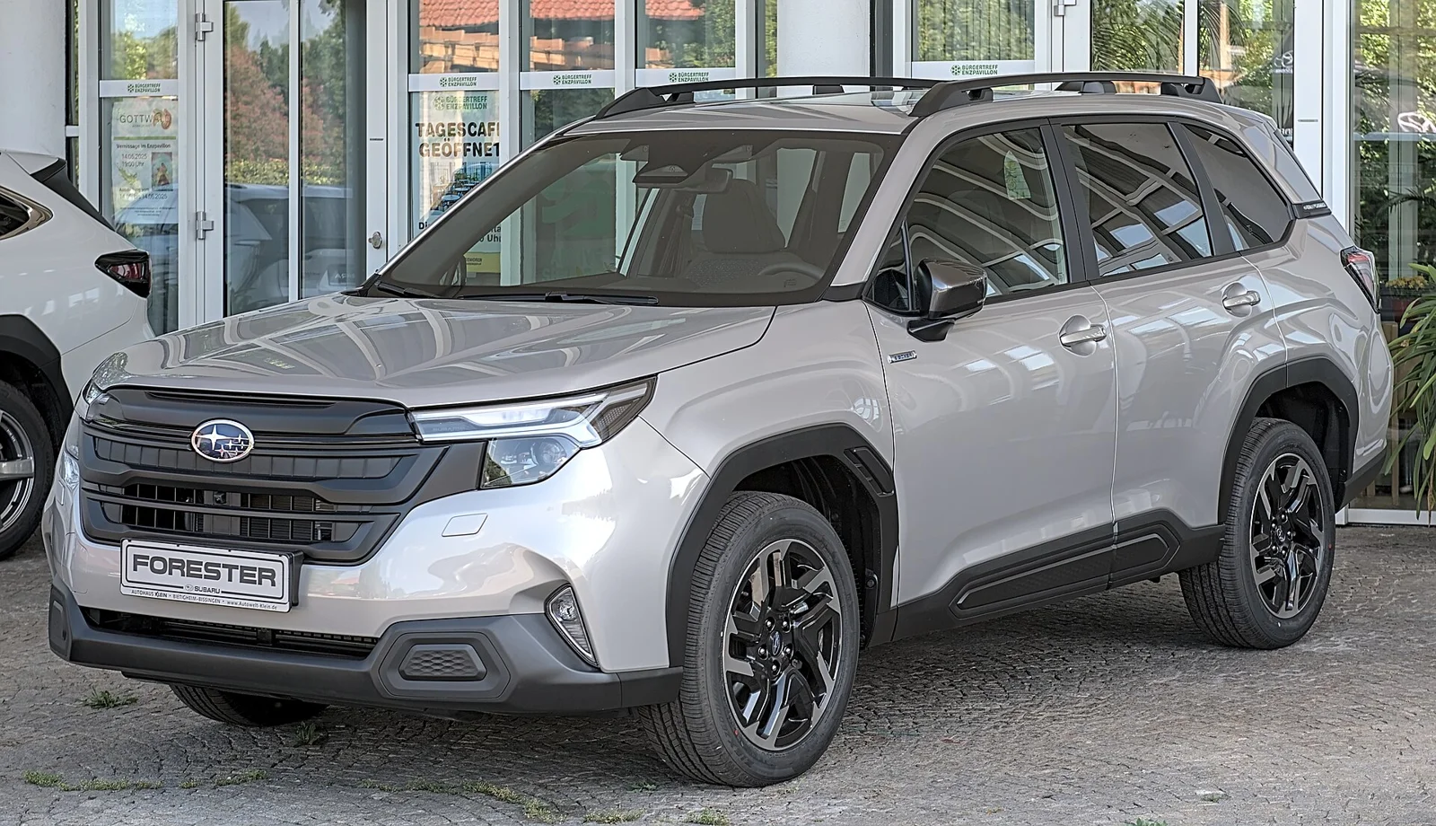Silver Subaru Forester, current sixth generation, front three-quarter view showing the new grille and headlights.