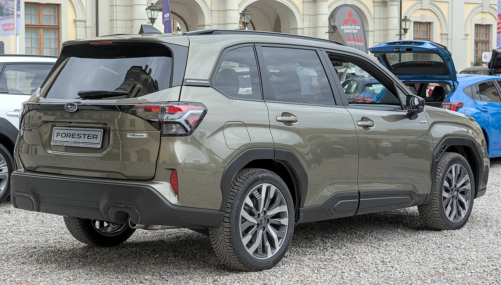 Green Subaru Forester, current sixth generation, rear three-quarter view showing the tailgate and cargo-area hatch.