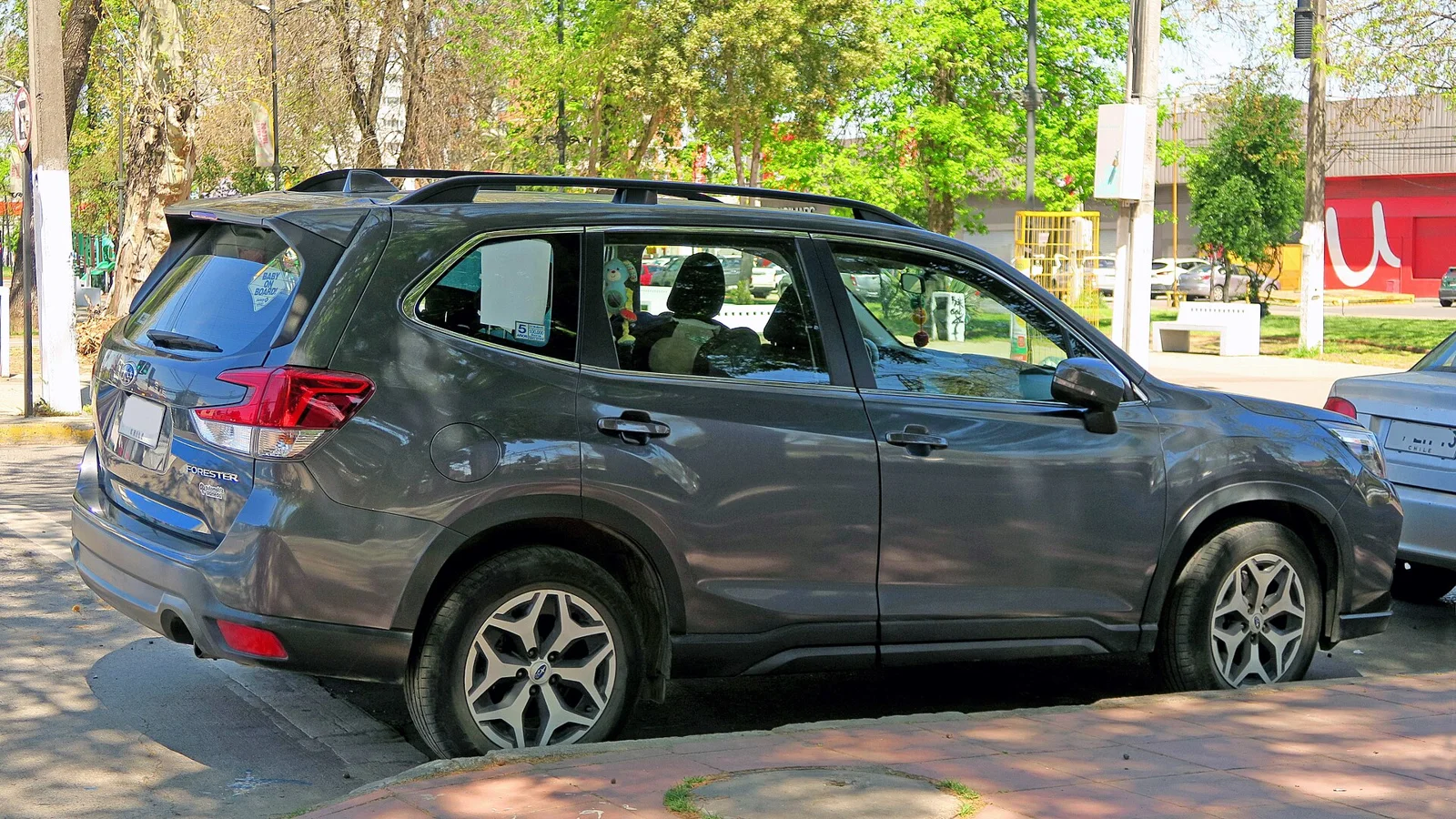 Grey-blue Subaru Forester, fifth-generation SK, rear three-quarter view parked on a street.