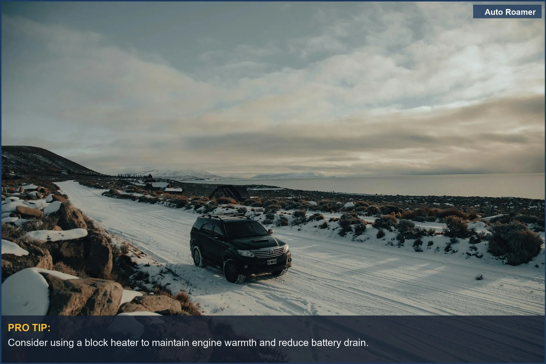 Black SUV driving through a scenic winter landscape, illustrating the impact of cold on vehicle performance.