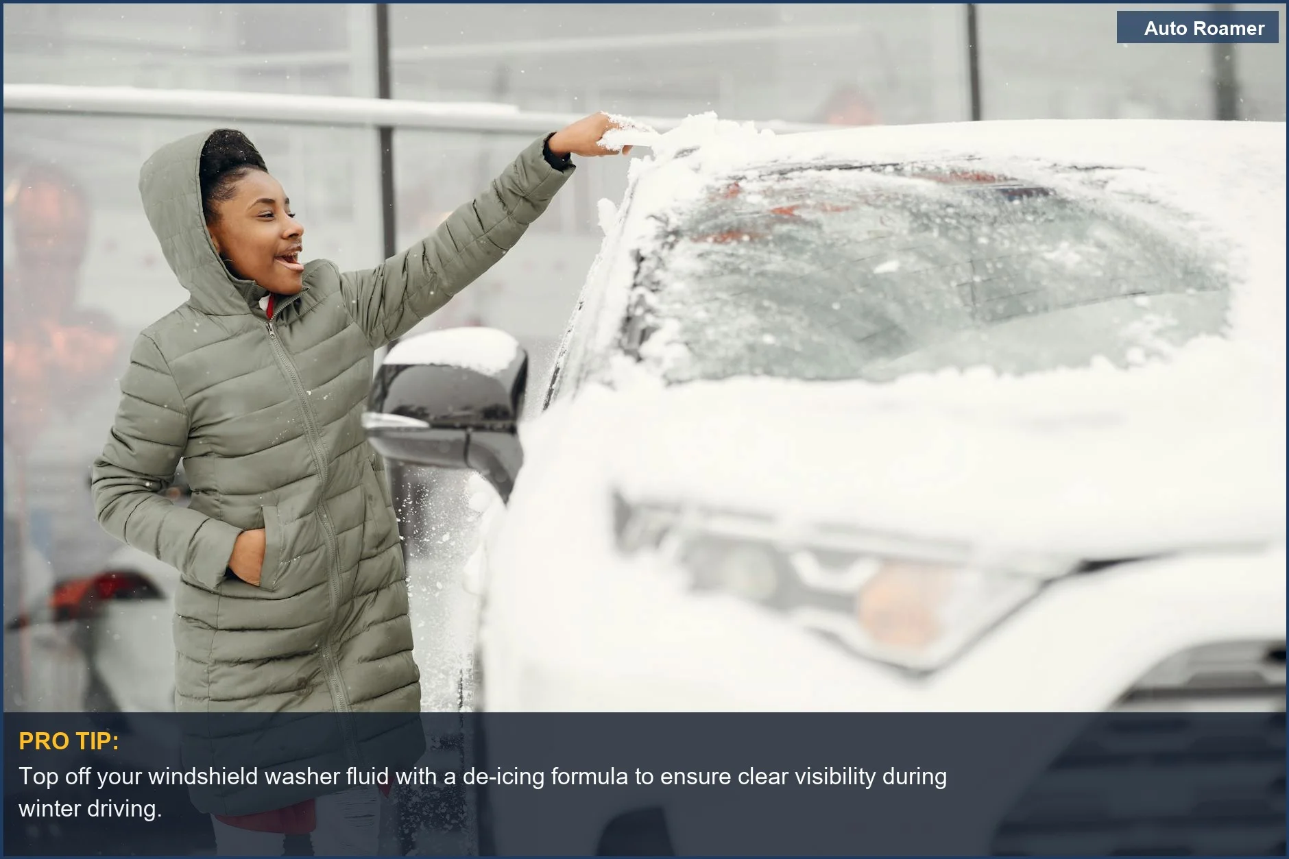 Woman clearing snow from windshield for essential winter car maintenance.